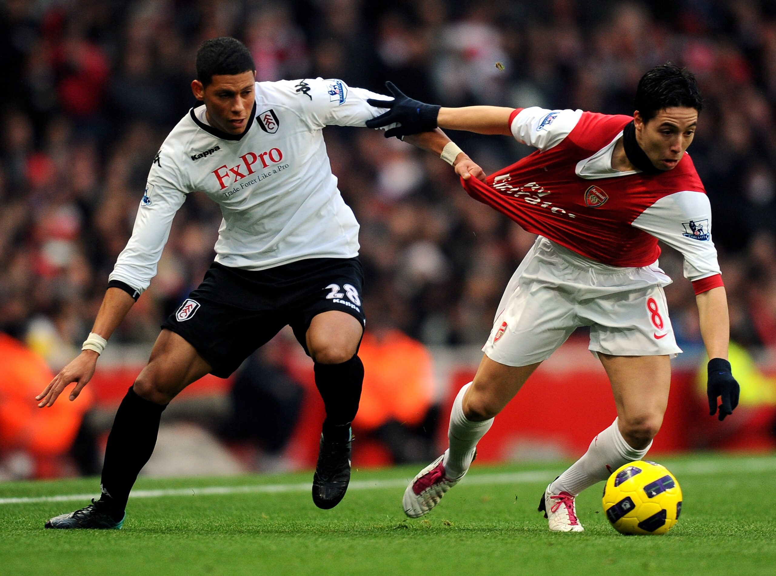 LONDON, ENGLAND - DECEMBER 04: Samir Nasri of Arsenal (R) is tackled by Matthew Briggs of Fulham during the Barclays Premier League match between Arsenal and Fulham at the Emirates Stadium on December 4, 2010 in London, England. (Photo by Mike Hewitt/Ge LONDON, ENGLAND - DECEMBER 04: Samir Nasri of Arsenal (R) is tackled by Matthew Briggs of Fulham during the Barclays Premier League match between Arsenal and Fulham at the Emirates Stadium on December 4, 2010 in London, England. (Photo by Mike Hewitt/Ge