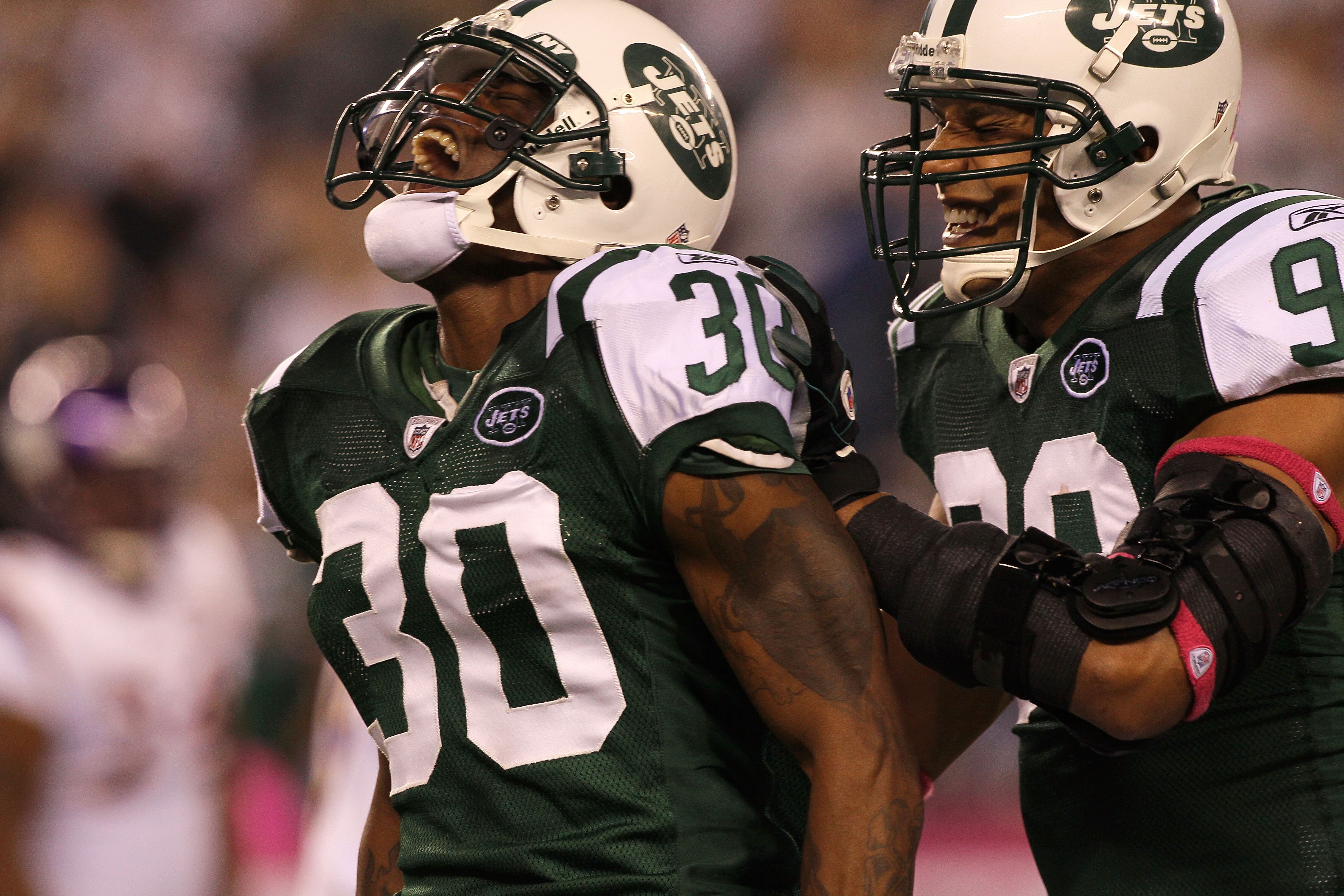 EAST RUTHERFORD, NJ - OCTOBER 11:  (L-R) Drew Coleman #30 and Jason Taylor #99 of the New York Jets reacts after Coleman recorded a sack against the Minnesota Vikings at New Meadowlands Stadium on October 11, 2010 in East Rutherford, New Jersey.  (Photo b