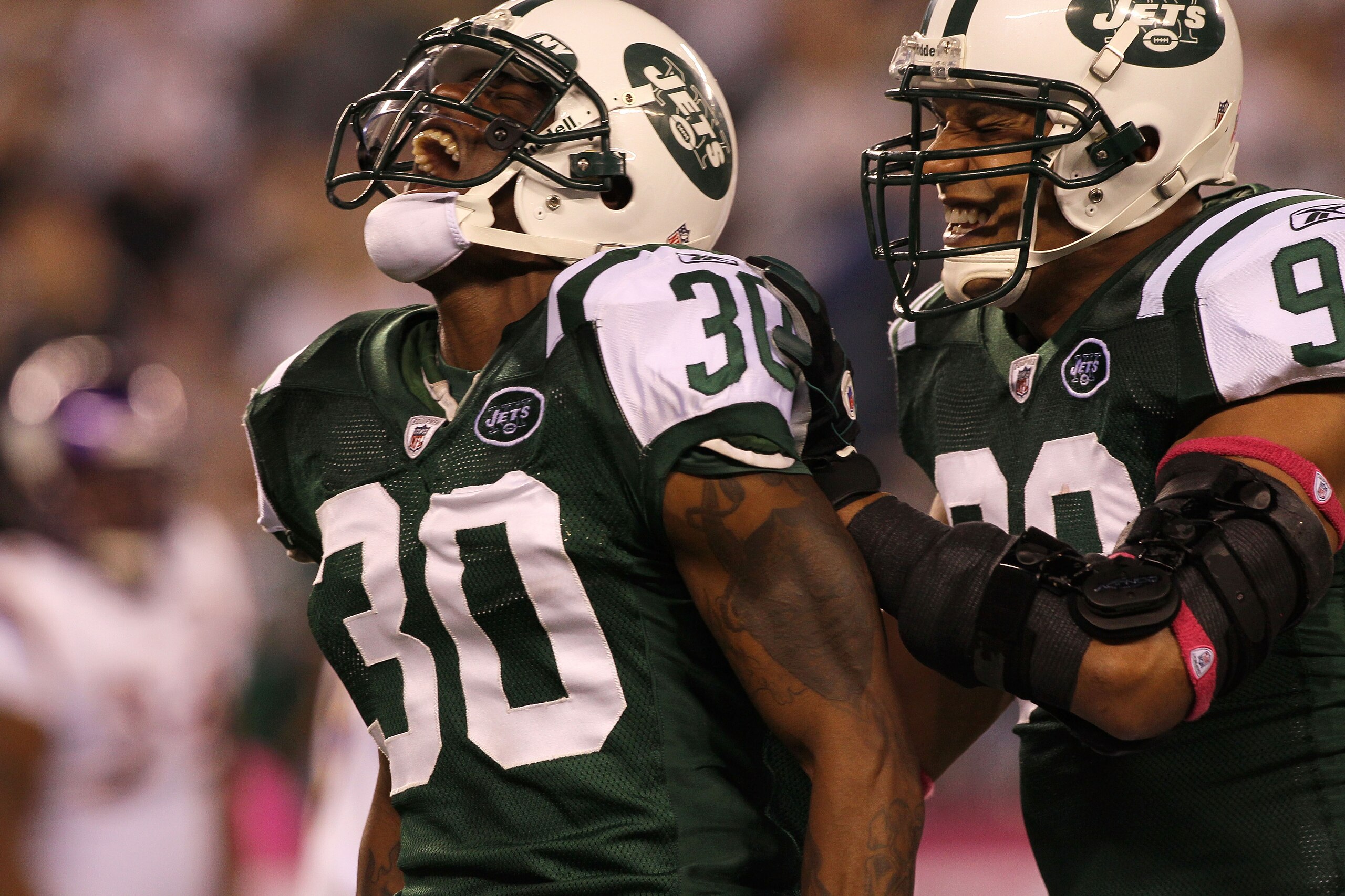 EAST RUTHERFORD, NJ - OCTOBER 11:  (L-R) Drew Coleman #30 and Jason Taylor #99 of the New York Jets reacts after Coleman recorded a sack against the Minnesota Vikings at New Meadowlands Stadium on October 11, 2010 in East Rutherford, New Jersey.  (Photo b