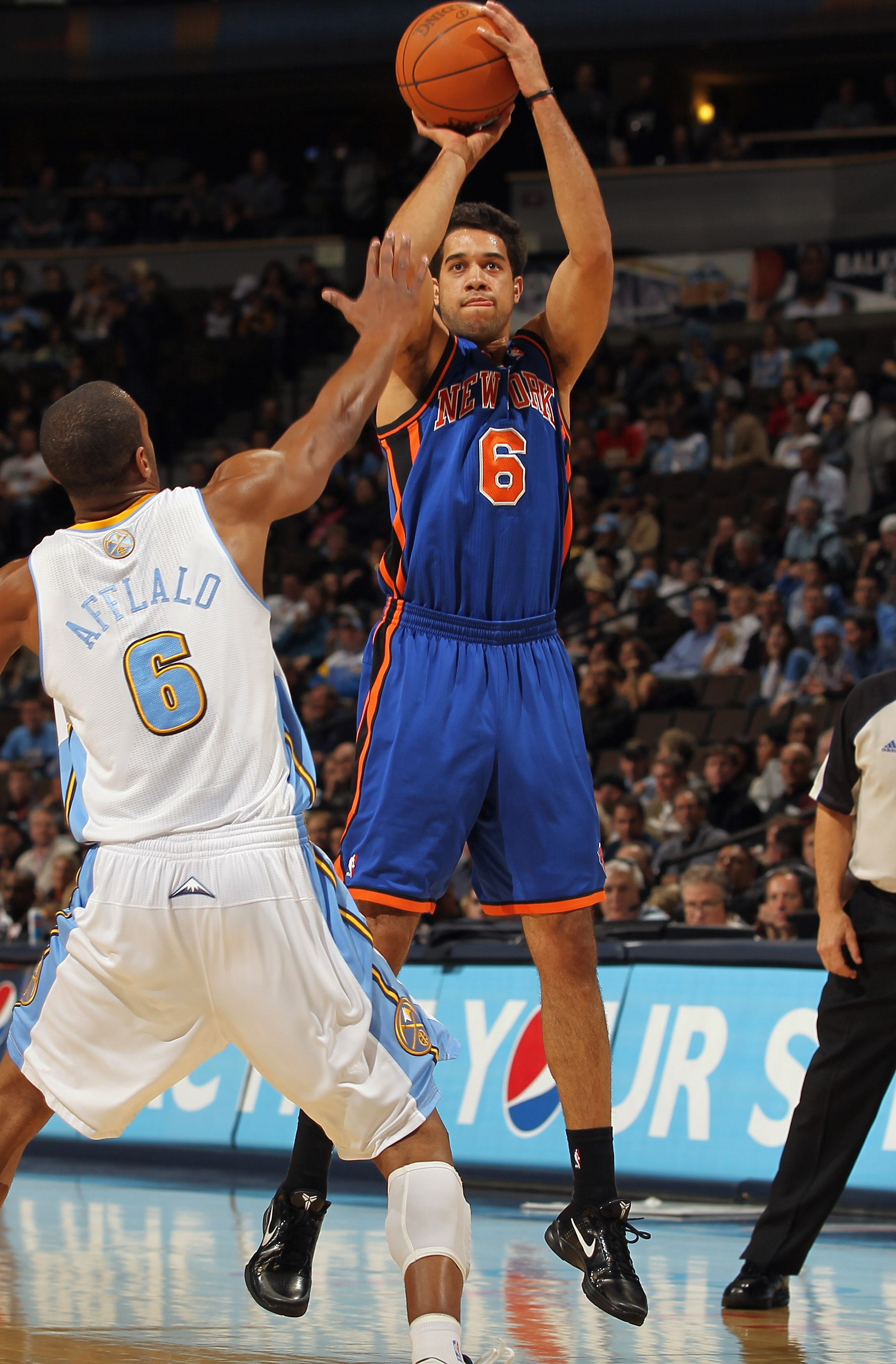 DENVER - NOVEMBER 16:  Landry Fields #6 of the New York Knicks takes a shot over Arron Afflalo #6 of the Denver Nuggets at the Pepsi Center on November 16, 2010 in Denver, Colorado. The Nuggets defeated the Knicks 120-118. NOTE TO USER: User expressly ack