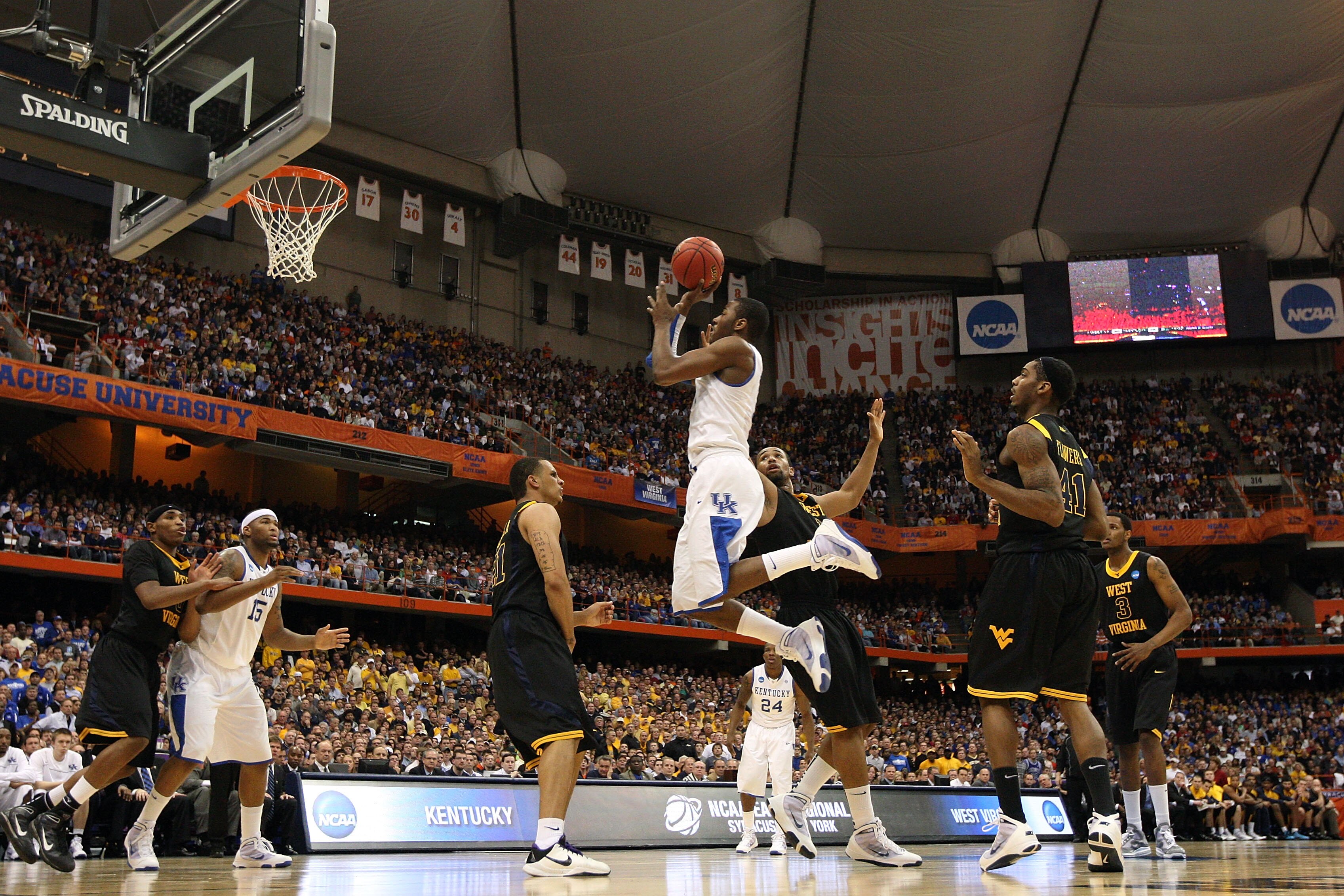SYRACUSE, NY - MARCH 27:  John Wall #11 of the Kentucky Wildcats drives for a shot attempt against the West Virginia Mountaineers during the east regional final of the 2010 NCAA men's basketball tournament at the Carrier Dome on March 27, 2010 in Syracuse
