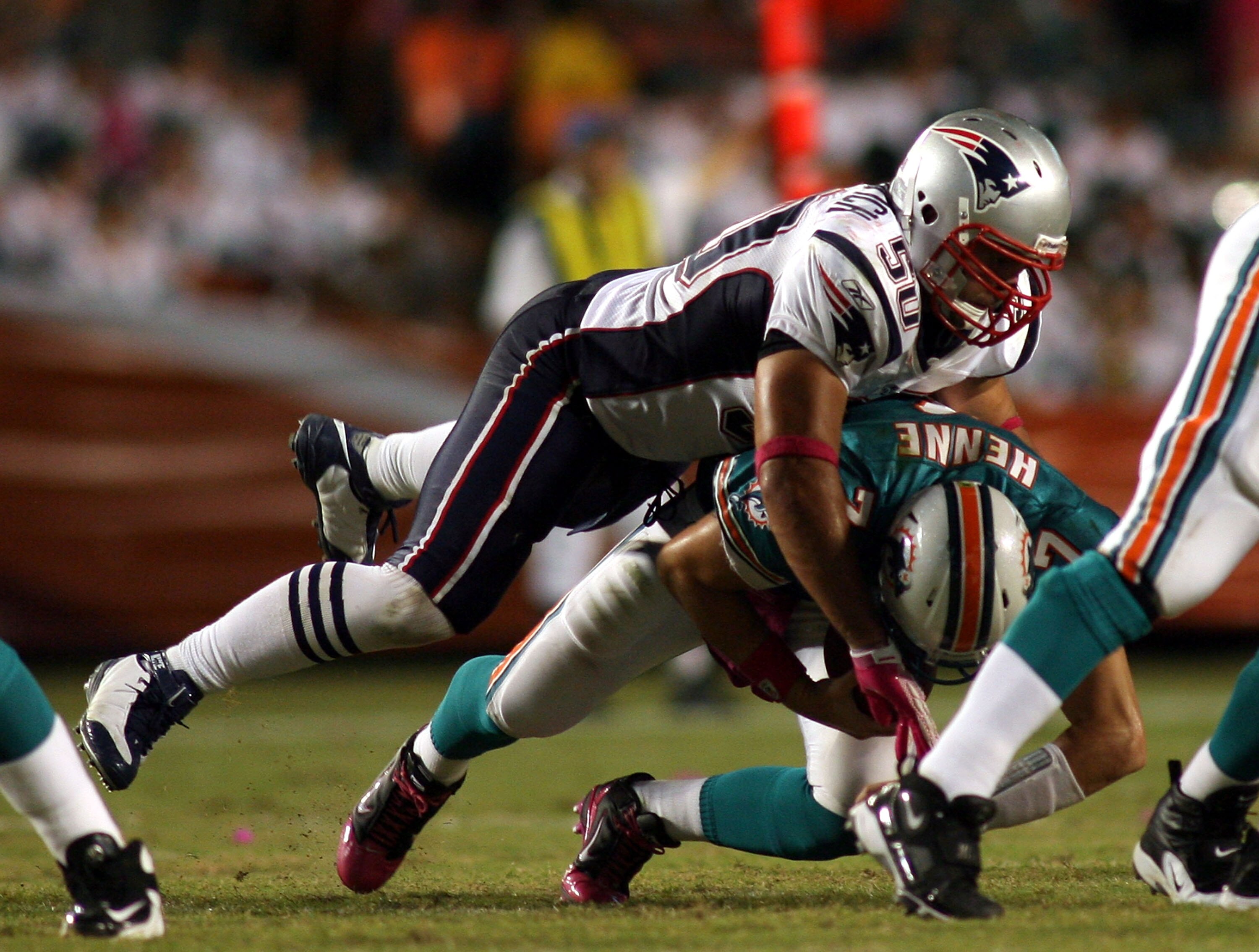 MIAMI - OCTOBER 04:  Quarterback Chad Henne #7 of the Miami Dolphinsis sacked by linebacker Rob Ninkovich #50 of the New England Patriots at Sun Life Stadium on October 4, 2010 in Miami, Florida.  (Photo by Marc Serota/Getty Images)