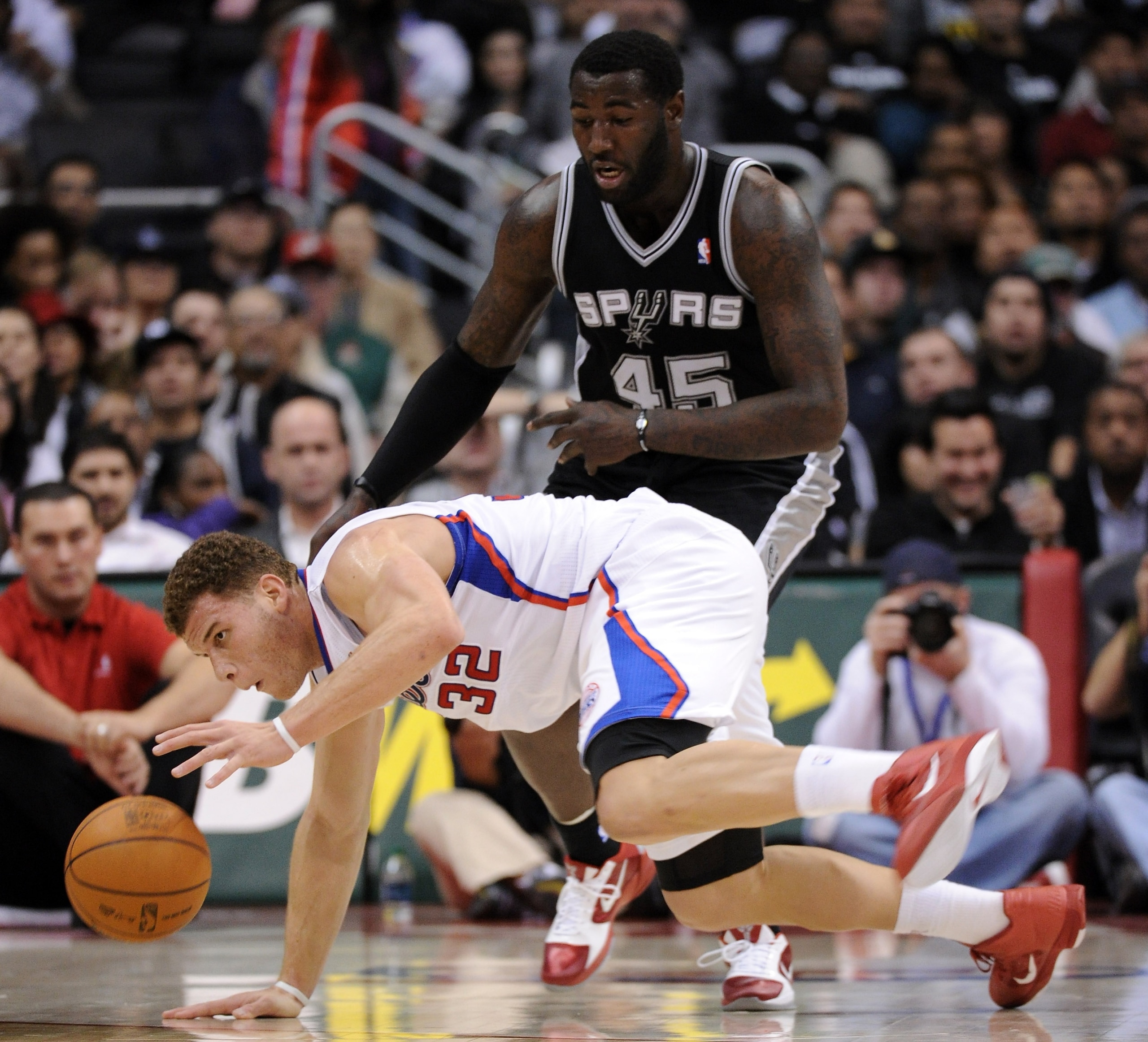 LOS ANGELES, CA - DECEMBER 01: Blake Griffin #32 of the Los Angeles Clippers keeps his dribble as he falls in front of DeJuan Blair #45 of the San Antonio Spurs during a 90-85 Clipper win at the Staples Center on December 1, 2010 in Los Angeles, Californ LOS ANGELES, CA - DECEMBER 01: Blake Griffin #32 of the Los Angeles Clippers keeps his dribble as he falls in front of DeJuan Blair #45 of the San Antonio Spurs during a 90-85 Clipper win at the Staples Center on December 1, 2010 in Los Angeles, Californ