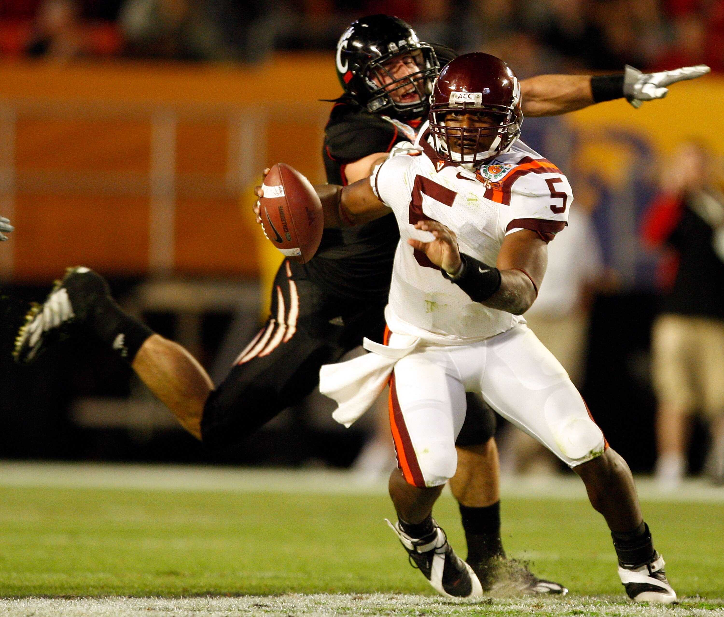 MIAMI - JANUARY 01:  Connor Barwin #5 of the Cincinnati Bearcats tries to tackle Tyrod Taylor #5 of the Virginia Tech Hokies during the FedEx Orange Bowl at Dolphin Stadium on January 1, 2009 in Miami, Florida.  (Photo by Streeter Lecka/Getty Images)