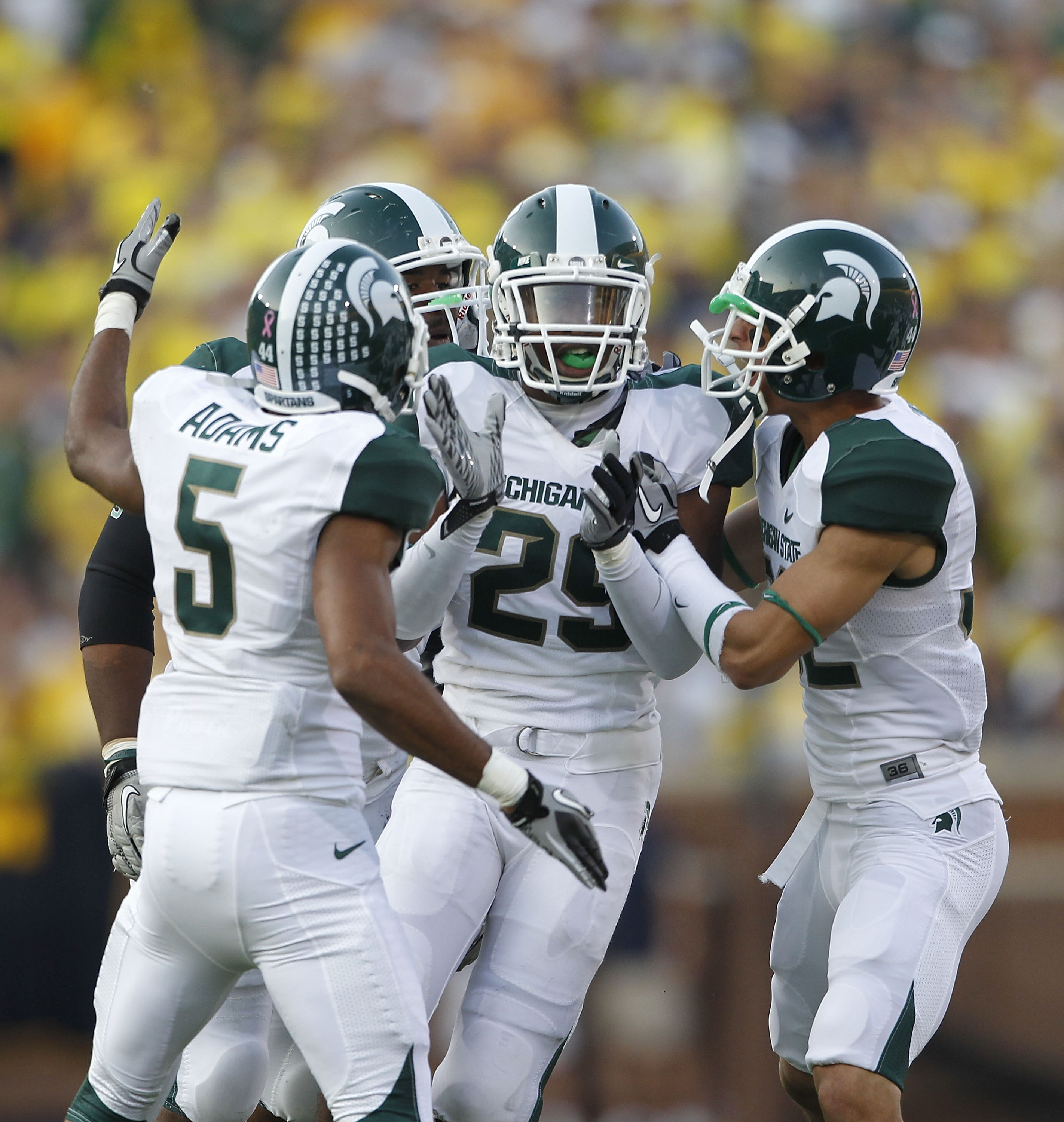 ANN ARBOR, MI - OCTOBER 09: Chris Rucker #29 of the Michigan State Spartans celebrate with his teammates after intercepting Denard Robinson #16 of the Michigan Wolverines during the fourth quarter of the game on October 9, 2010 at Michigan Stadium in Ann 