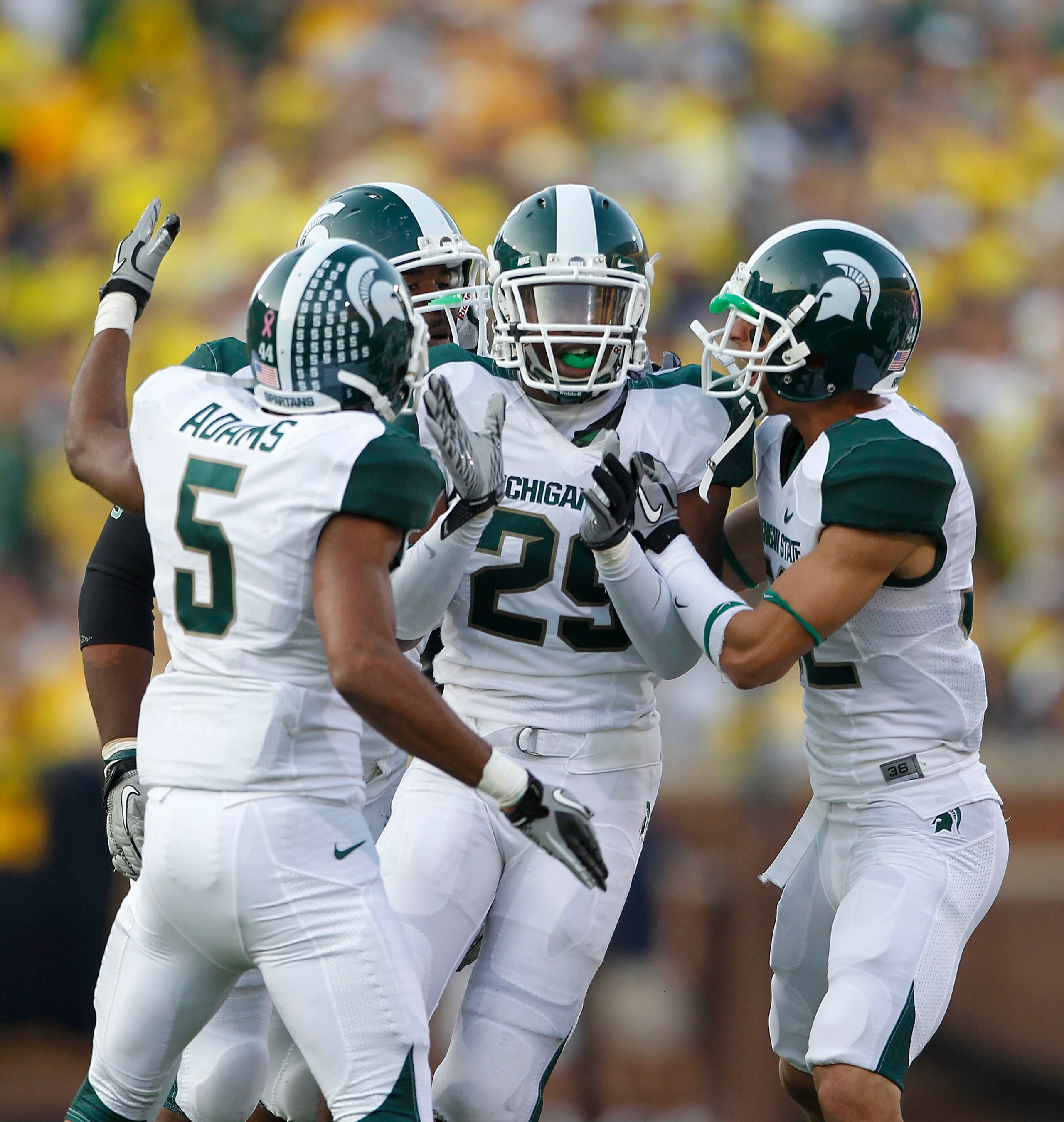 ANN ARBOR, MI - OCTOBER 09: Chris Rucker #29 of the Michigan State Spartans celebrate with his teammates after intercepting Denard Robinson #16 of the Michigan Wolverines during the fourth quarter of the game on October 9, 2010 at Michigan Stadium in Ann 