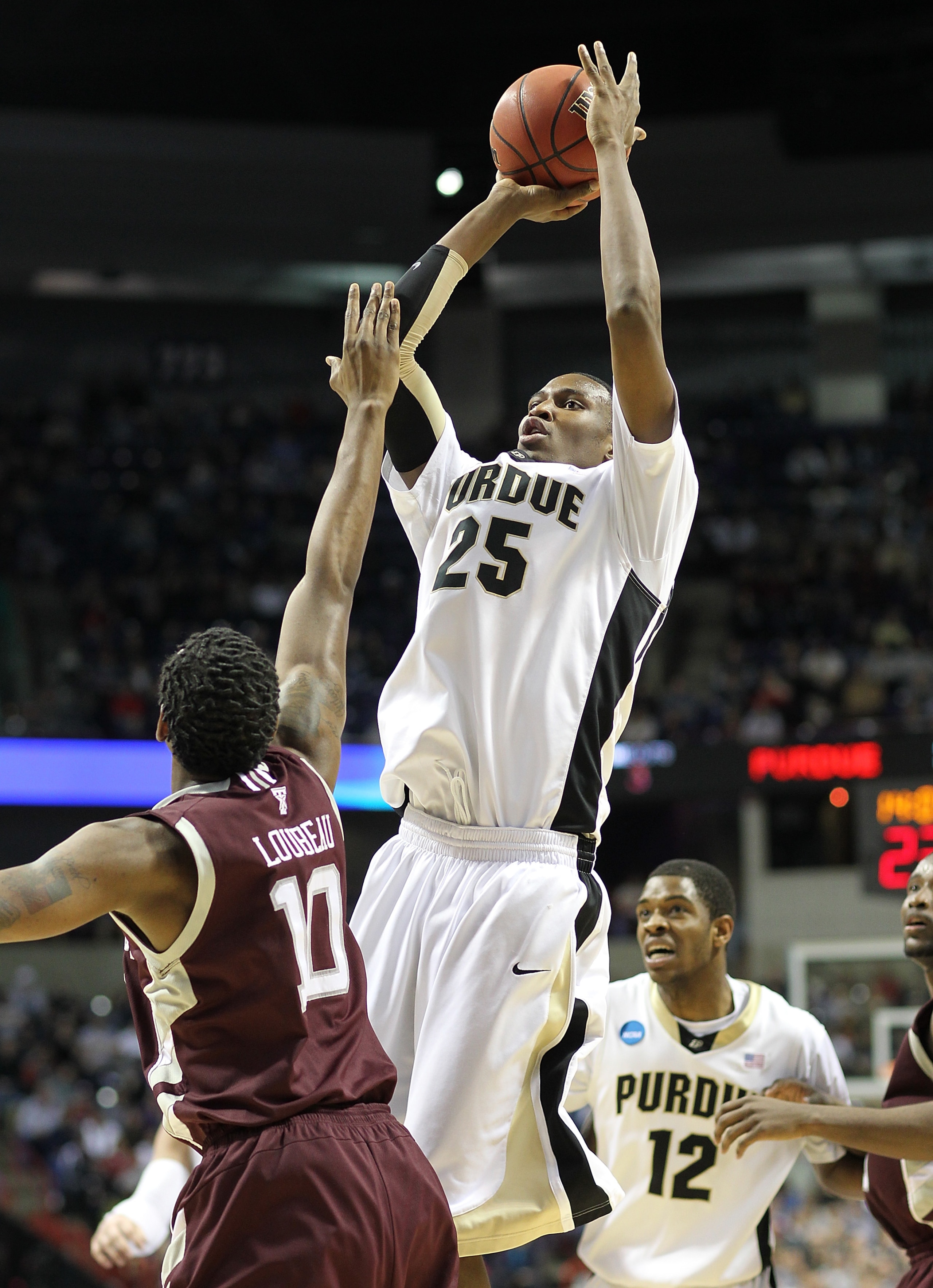 SPOKANE - MARCH 21:  JaJuan Johnson #25 of the Purdue Boilermakers shoots against David Loubeau #10 of the Texas A&M Aggies during the second round of the 2010 NCAA men's basketball tournament at the Spokane Arena on March 21, 2010 in Spokane, Washington.