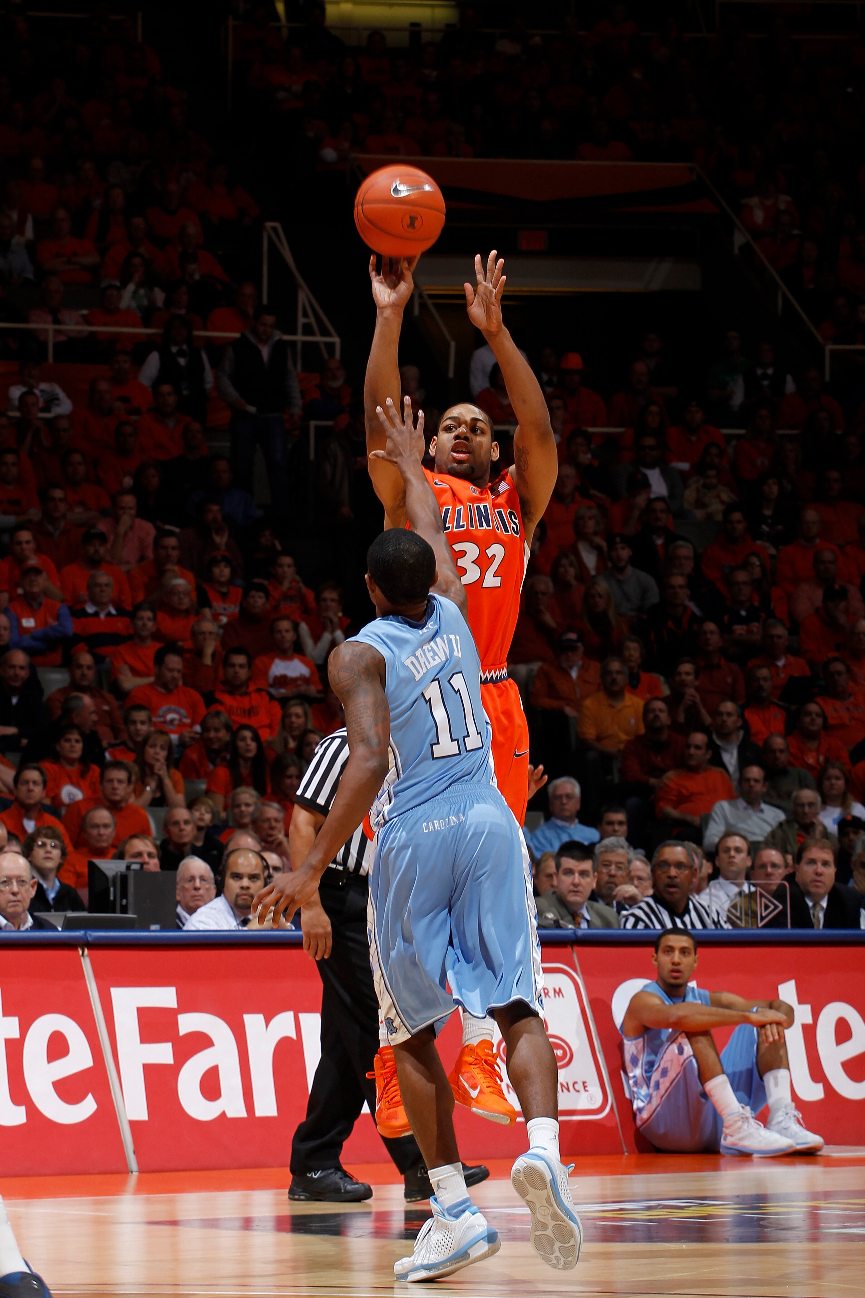 CHAMPAIGN, IL - NOVEMBER 30: Demetri McCamey #32 of the Illinois Fighting Illini takes a shot over Larry Drew II #11 of the North Carolina Tar Heels during first half action of the 2010 ACC/Big Ten Challenge at Assembly Hall on November 30, 2010 in Champa