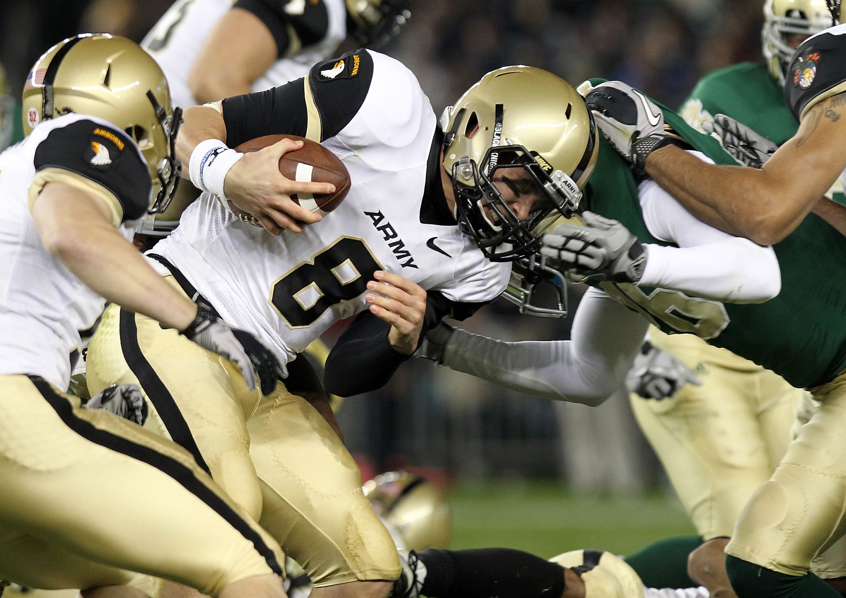 NEW YORK - NOVEMBER 20:  Trent Steelman #8 of the Army Black Knights is tackled against the Notre Dame Fighting Irish at Yankee Stadium on November 20, 2010 in the Bronx borough of New York City.  (Photo by Nick Laham/Getty Images)