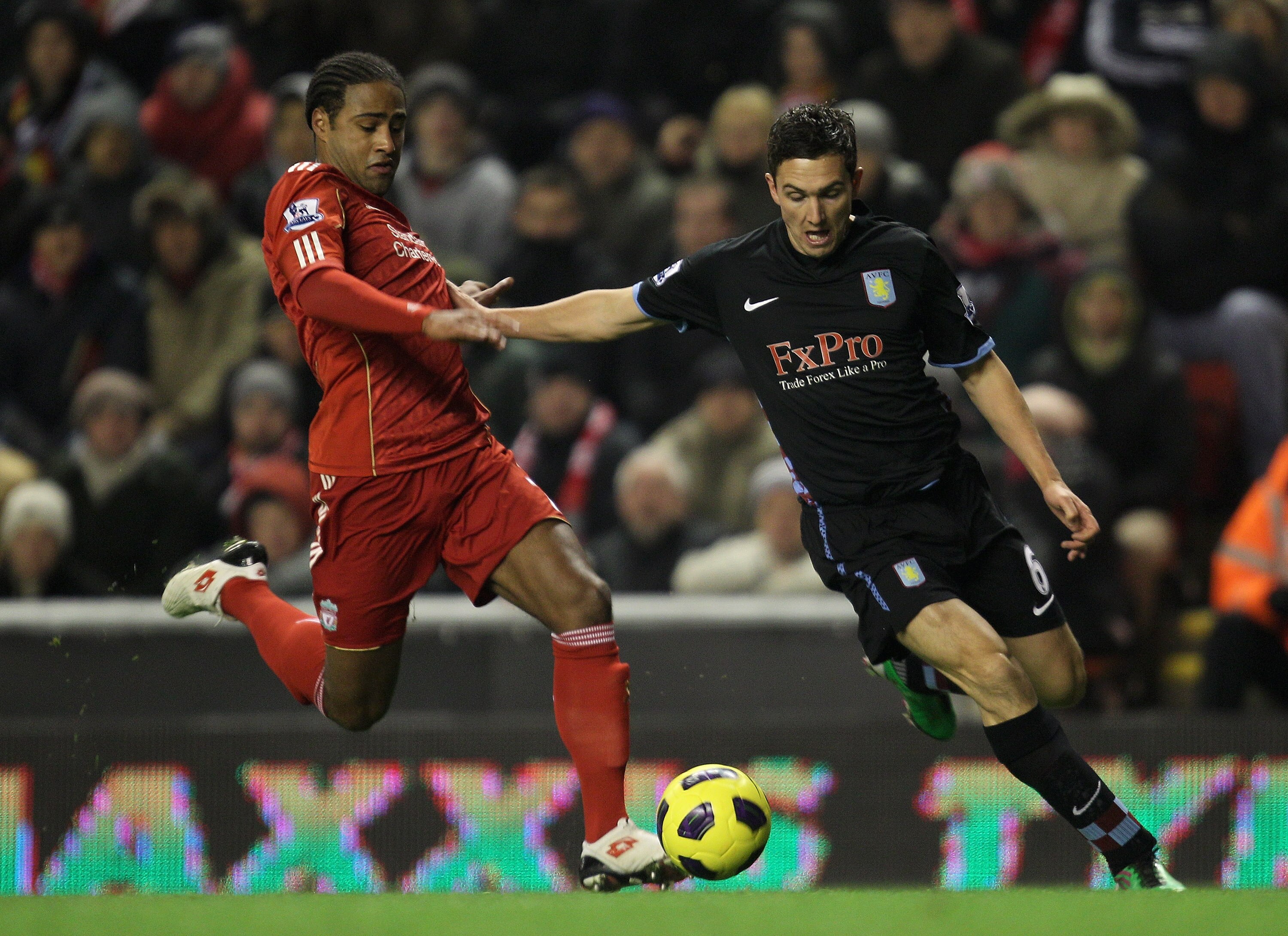 LIVERPOOL, ENGLAND - DECEMBER 06:   Stewart Downing of Aston Villa  is challenged by Glen Johnson of Liverpool during the Barclays Premier League match between Liverpool and Aston Villa at Anfield on December 6, 2010 in Liverpool, England. (Photo by Mark