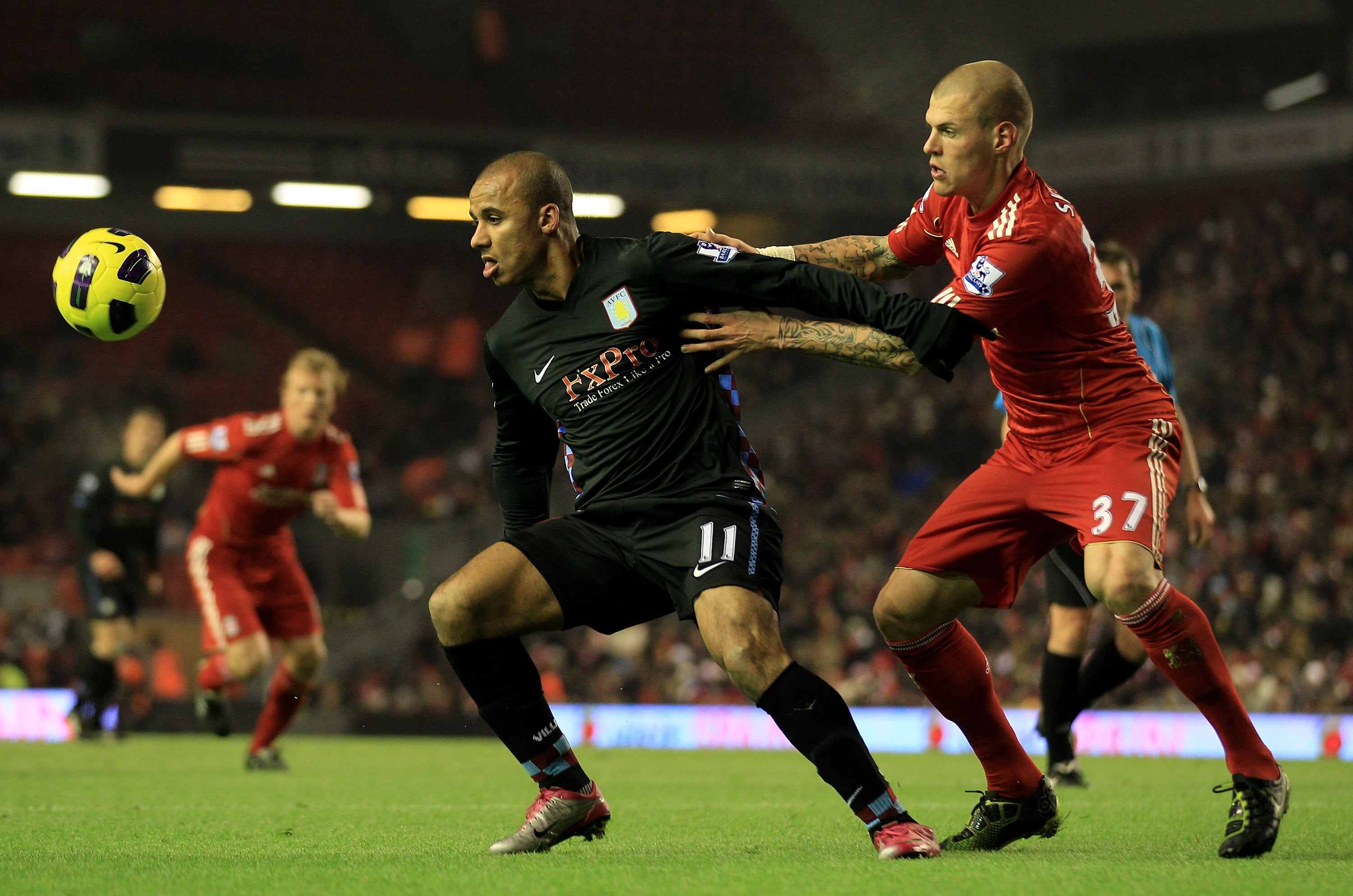 LIVERPOOL, ENGLAND - DECEMBER 06:  Gabriel Agbonlahor of Aston Villa holds off Martin Skrtel of Liverpool during the Barclays Premier League match between Liverpool and Aston Villa at Anfield on December 6, 2010 in Liverpool, England. (Photo by Mark Thomp