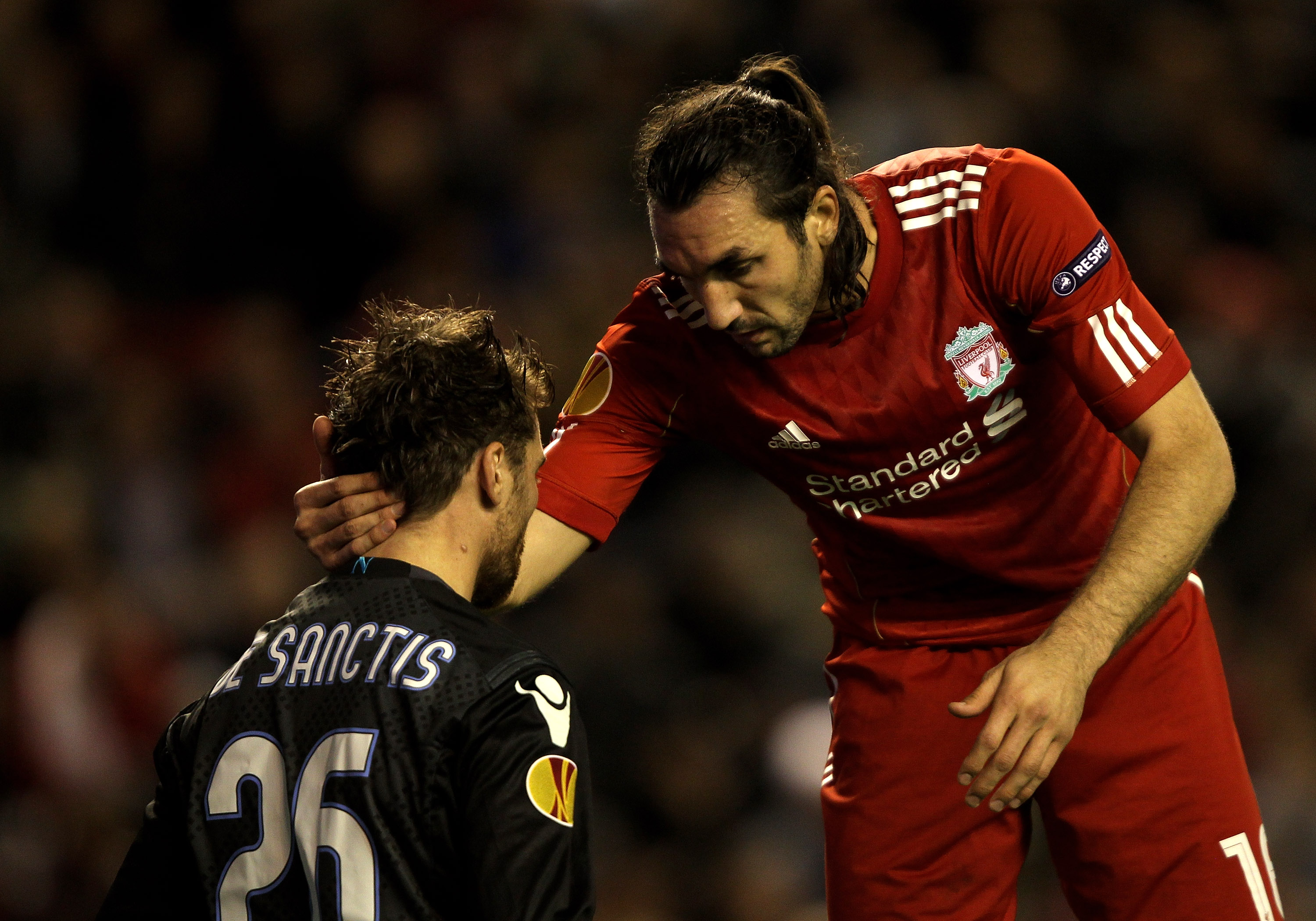 LIVERPOOL, ENGLAND - NOVEMBER 04:   Morgan De Sanctis of Napoli is consoled by Sotiros Kyrgiakos of Liverpool during the UEFA Europa League Group K match beteween Liverpool and SSC Napoli at Anfield on November 4, 2010 in Liverpool, England.  (Photo by Cl
