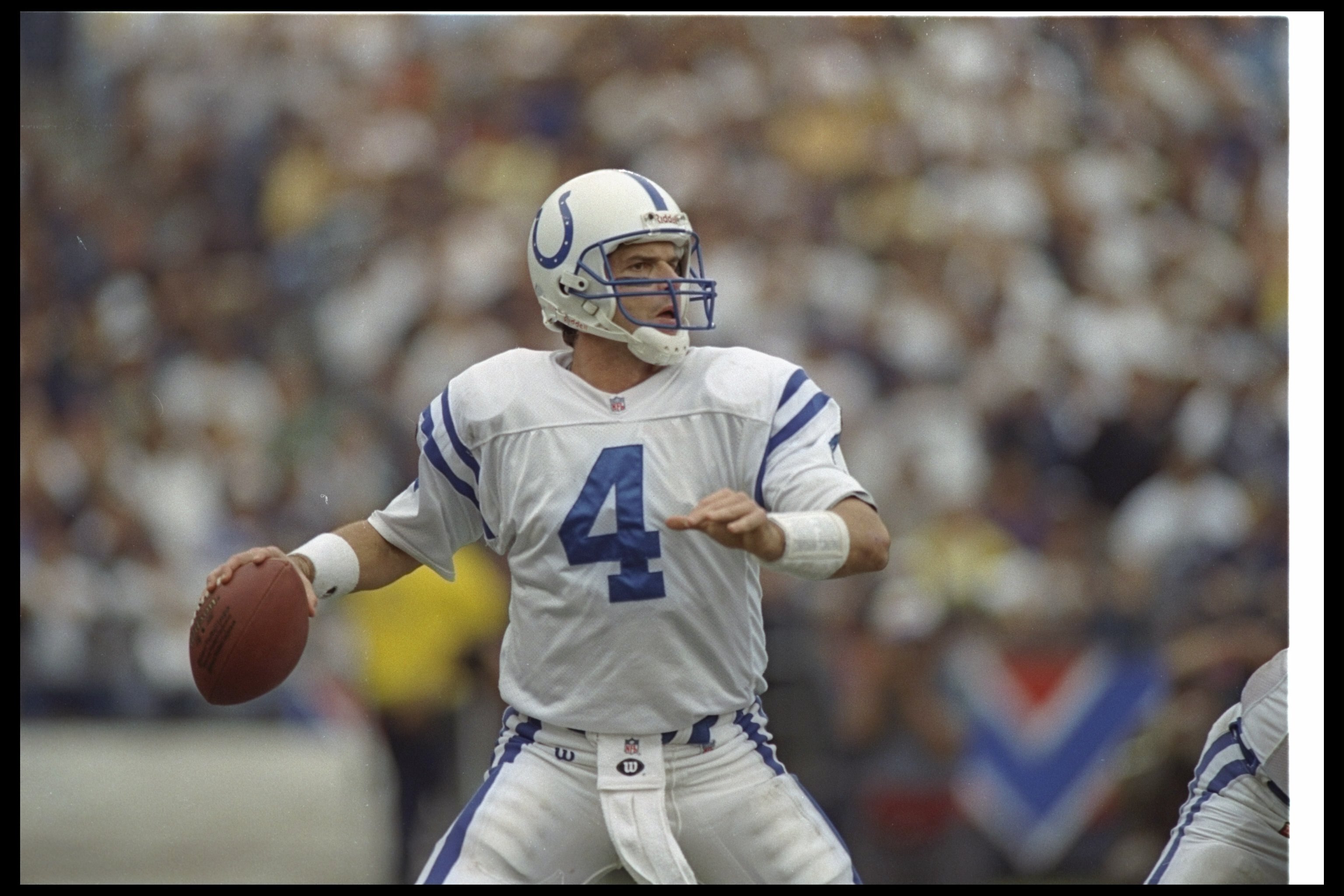 31 Dec 1995:  Quarterback Jim Harbaugh of the Indianapolis Colts looks to pass the ball during a playoff game against the San Diego Chargers at Jack Murphy Stadium in San Diego, California.  The Colts won the game, 35-20. Mandatory Credit: Stephen Dunn  /