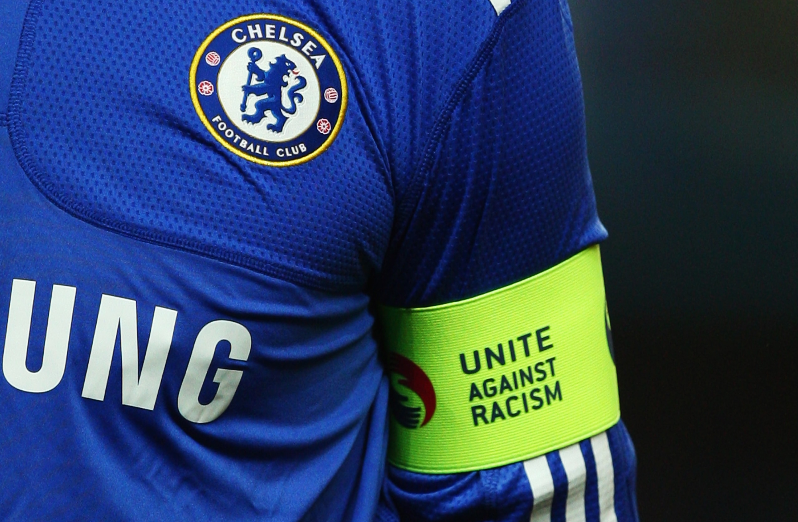 LONDON - OCTOBER 21:  A detailed view of the Chelsea badge and 'Unite Against Racism' captain's armband worn by John Terry prior to the UEFA Champions League Group D match between Chelsea and Atletico Madrid at Stamford Bridge on October 21, 2009 in Londo