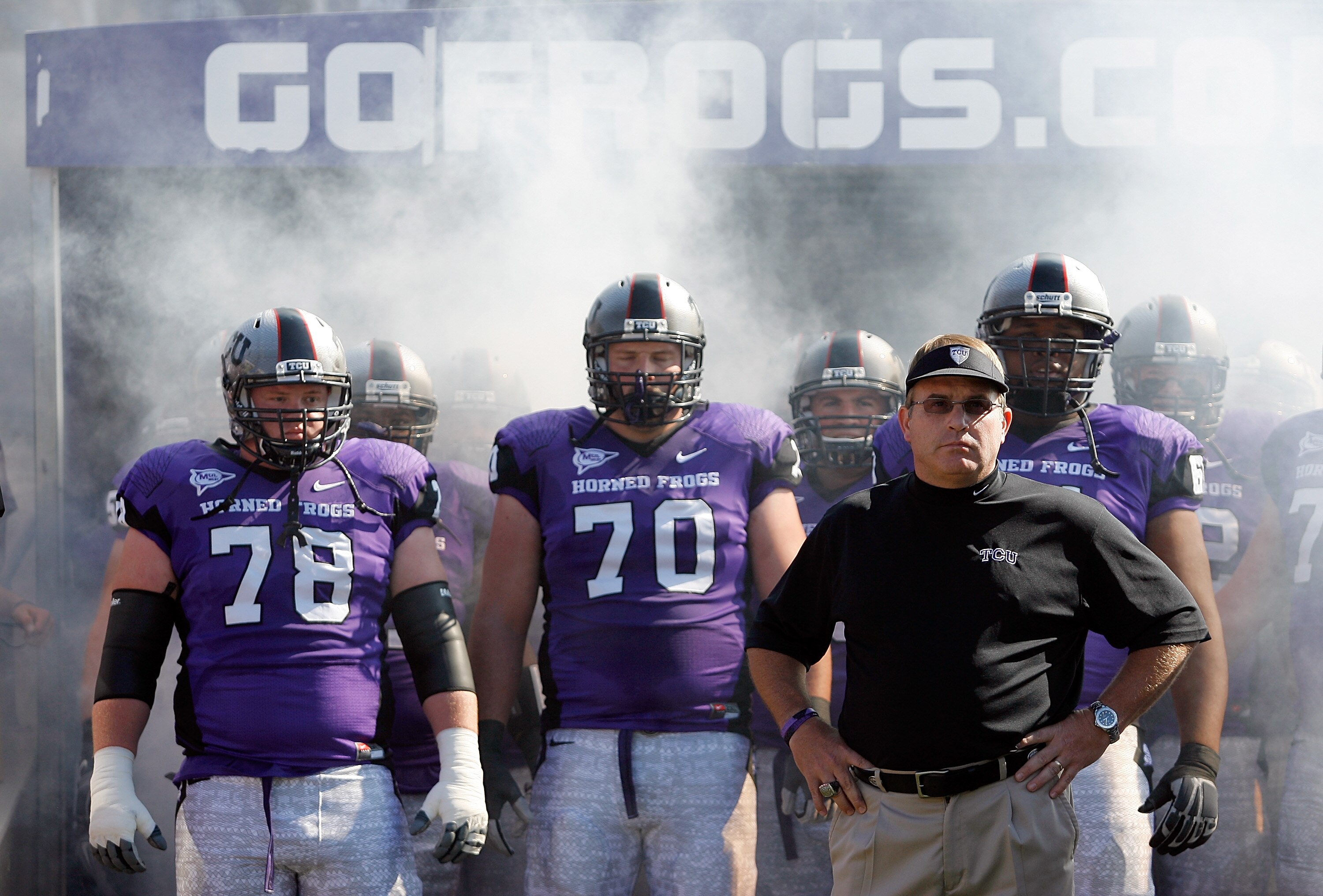 FORT WORTH, TX - OCTOBER 16:  Head coach Gary Patterson of the TCU Horned Frogs takes to the field with offensive guard Josh Vernon #78 and tackle Zach Roth #70 against the BYU Cougars at Amon G. Carter Stadium on October 16, 2010 in Fort Worth, Texas.  (