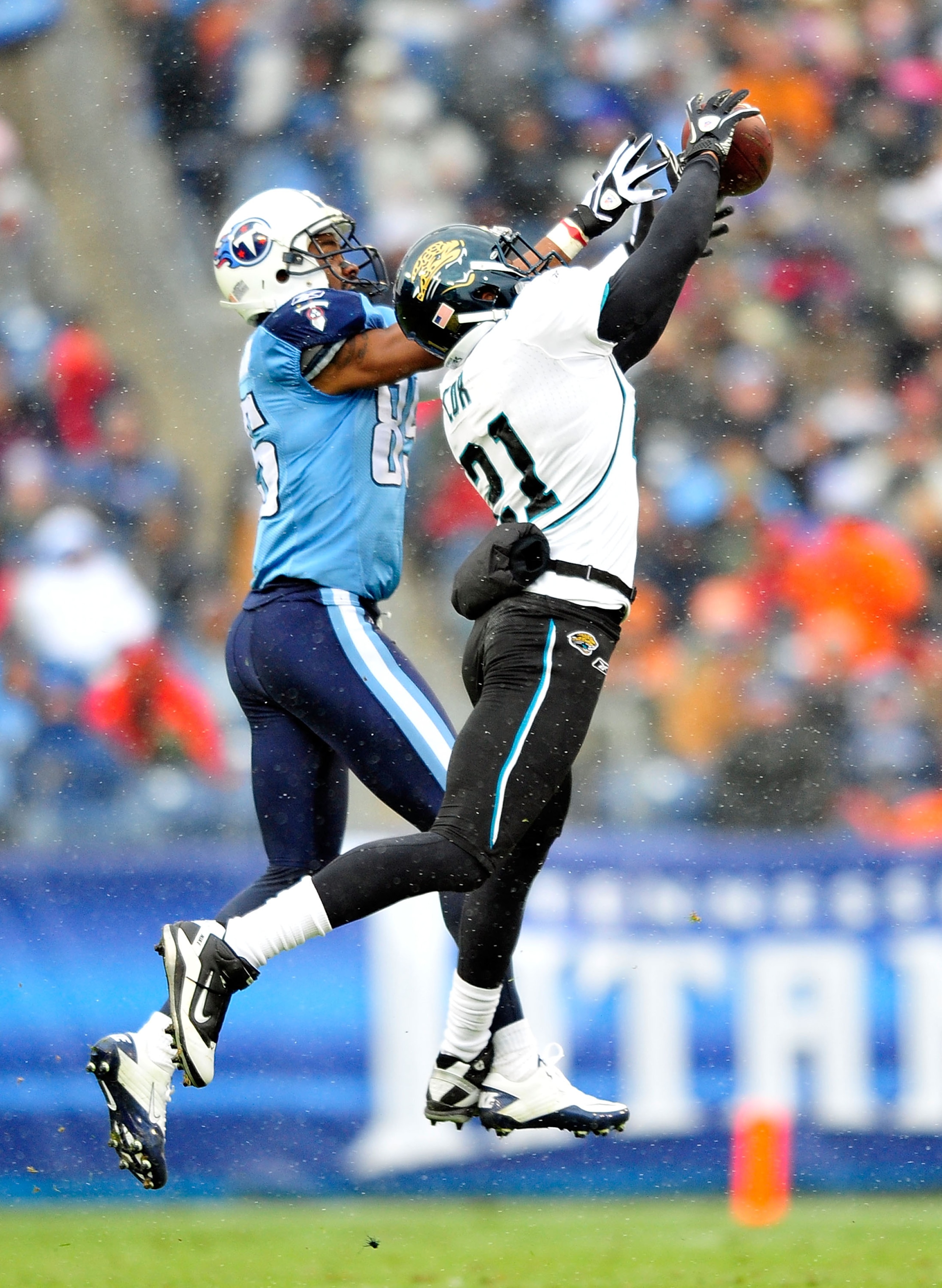 NASHVILLE, TN - DECEMBER 05:  Derek Cox #21 of the Jacksonville Jaguars intercepts a pass intended for Nate Washington #85 of the Tennessee Titans  during the first half at LP Field on December 5, 2010 in Nashville, Tennessee.  (Photo by Grant Halverson/G