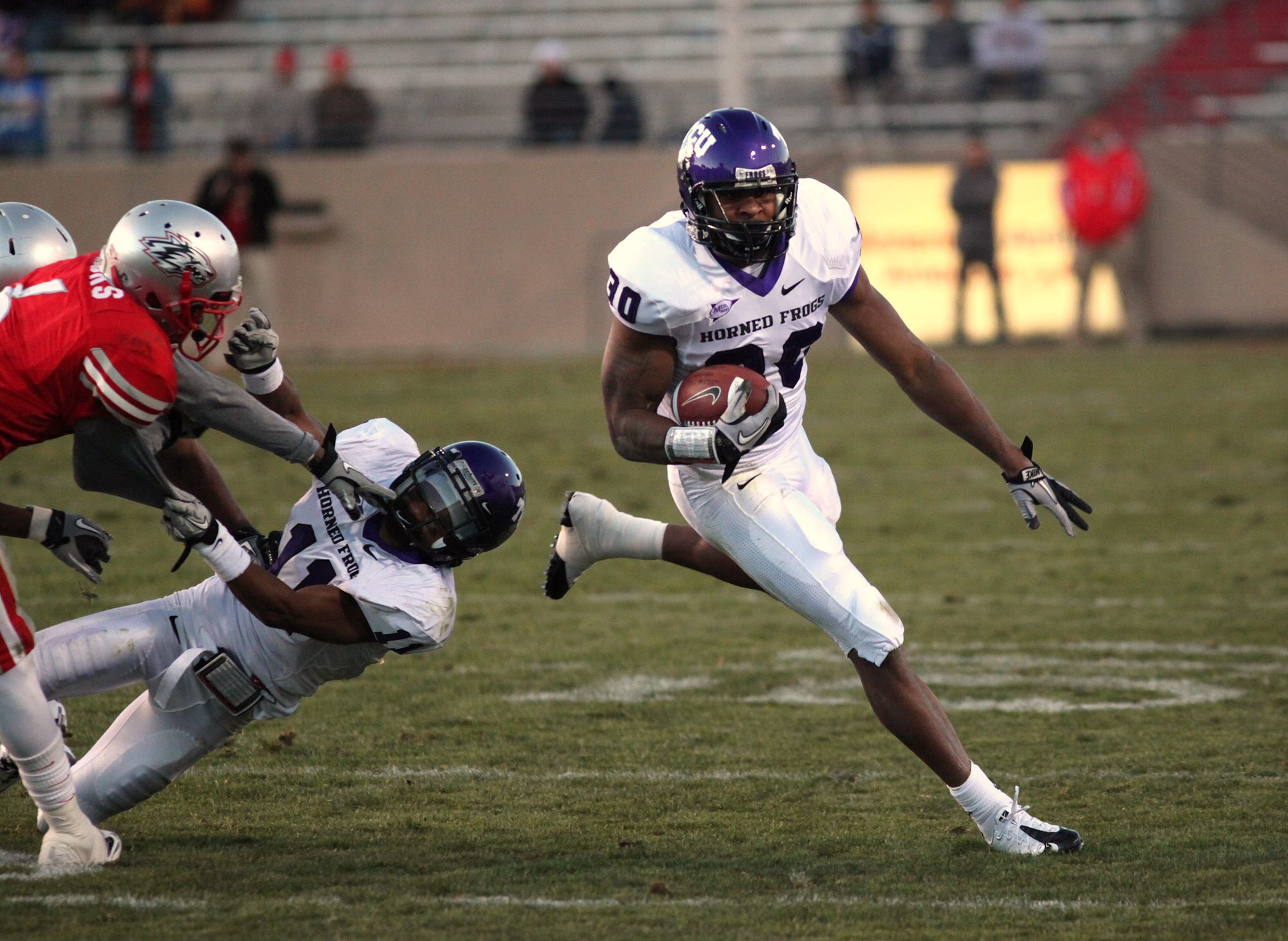 ALBUQUERQUE, NM - NOVEMBER 27: Andre Dean #30 of the TCU Horned Frogs carries the ball against the University of New Mexico Lobos in the 3rd quarter on November 27, 2010 at University Stadium in Albuquerque, New Mexico. TCU won 66-17. Also pictured is TCU