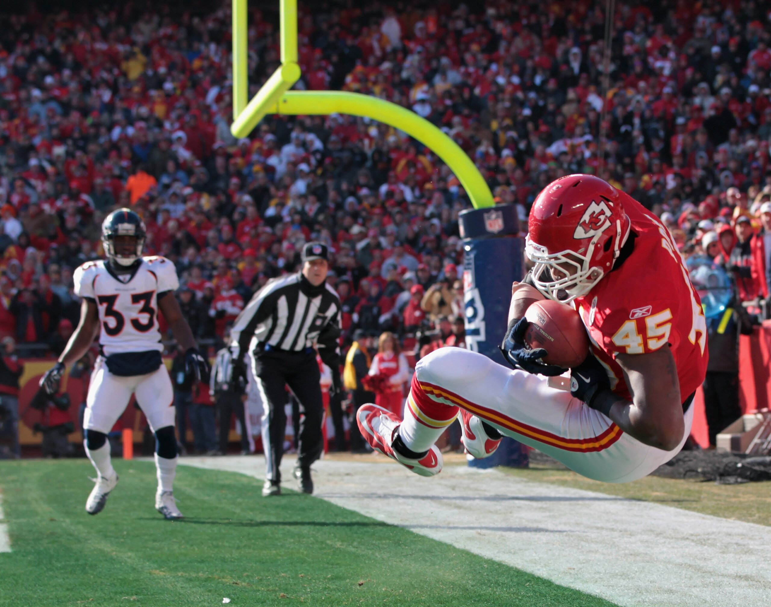 KANSAS CITY, MO - DECEMBER 05:  Leonard Pope #45 of the Kansas City Chiefs makes a catch in the endzone for a touchdown as Nate Jones #33 of the Denver Broncos looks on during the game on December 5, 2010 at Arrowhead Stadium in Kansas City, Missouri.  (P