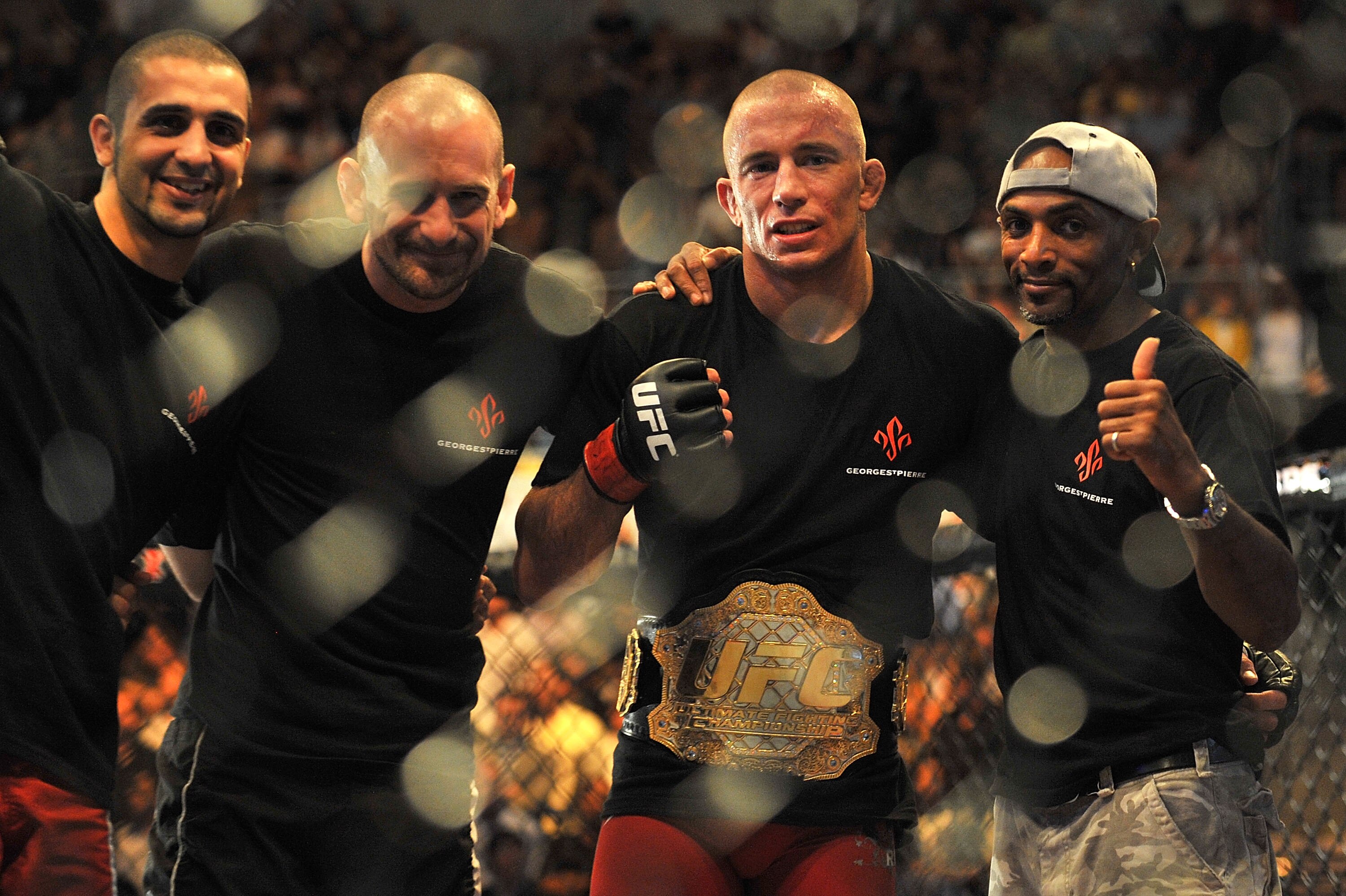 LAS VEGAS - JULY 11:  (2nd R) Georges St. Pierre celebrates his victory against Thiago Alves during their welterweight title bout during UFC 100 on July 11, 2009 in Las Vegas, Nevada. St. Pierre defeated Alves by unanimous decision.  (Photo by Jon Kopalof