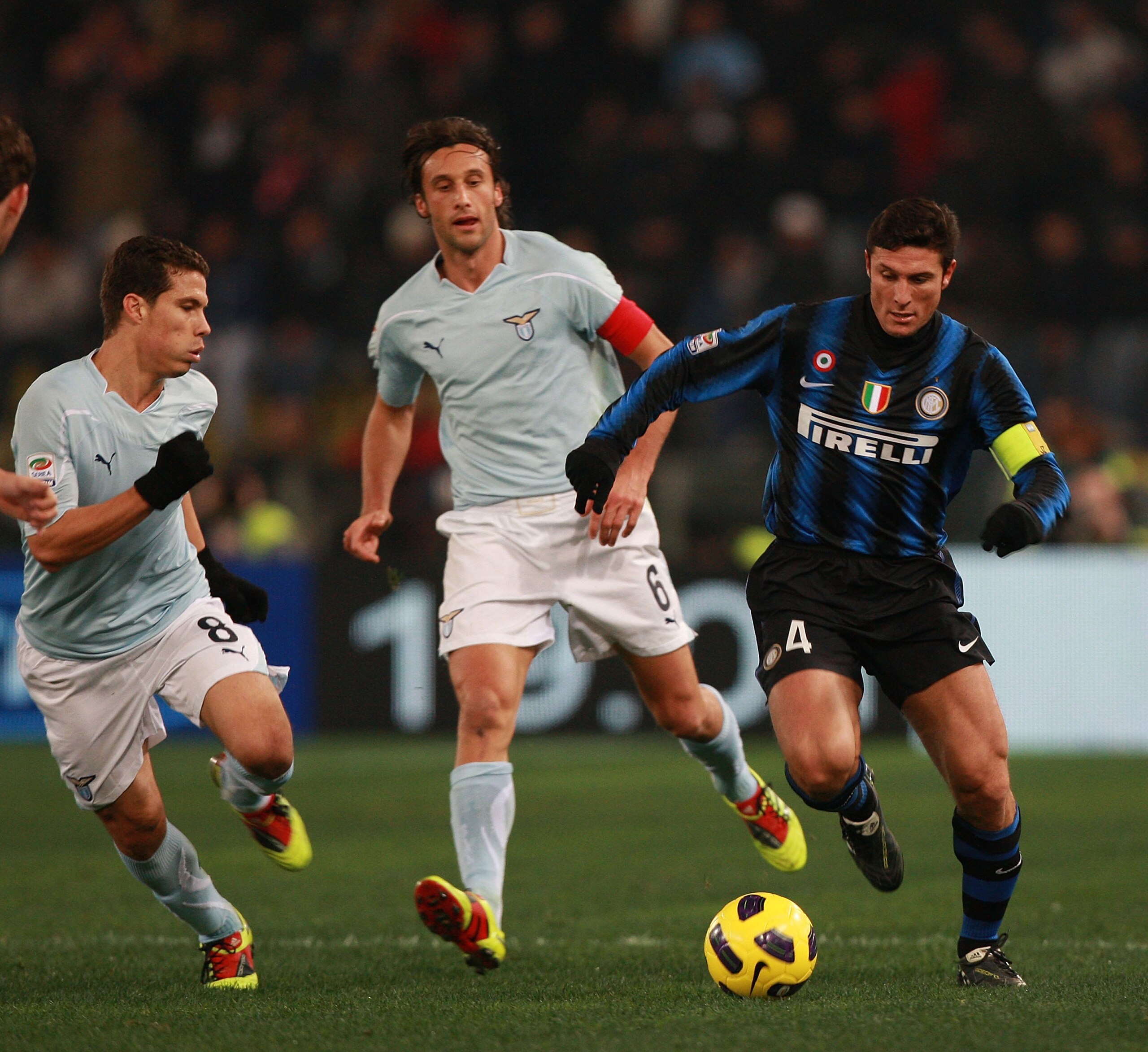 ROME, ITALY - DECEMBER 03:  Stefano Mauri (C) and Hernanes (L) of SS Lazio competes for the ball with Javier Zanetti of FC Internazionale Milano during the Serie A match between SS Lazio and FC Internazionale Milano at Stadio Olimpico on December 3, 2010