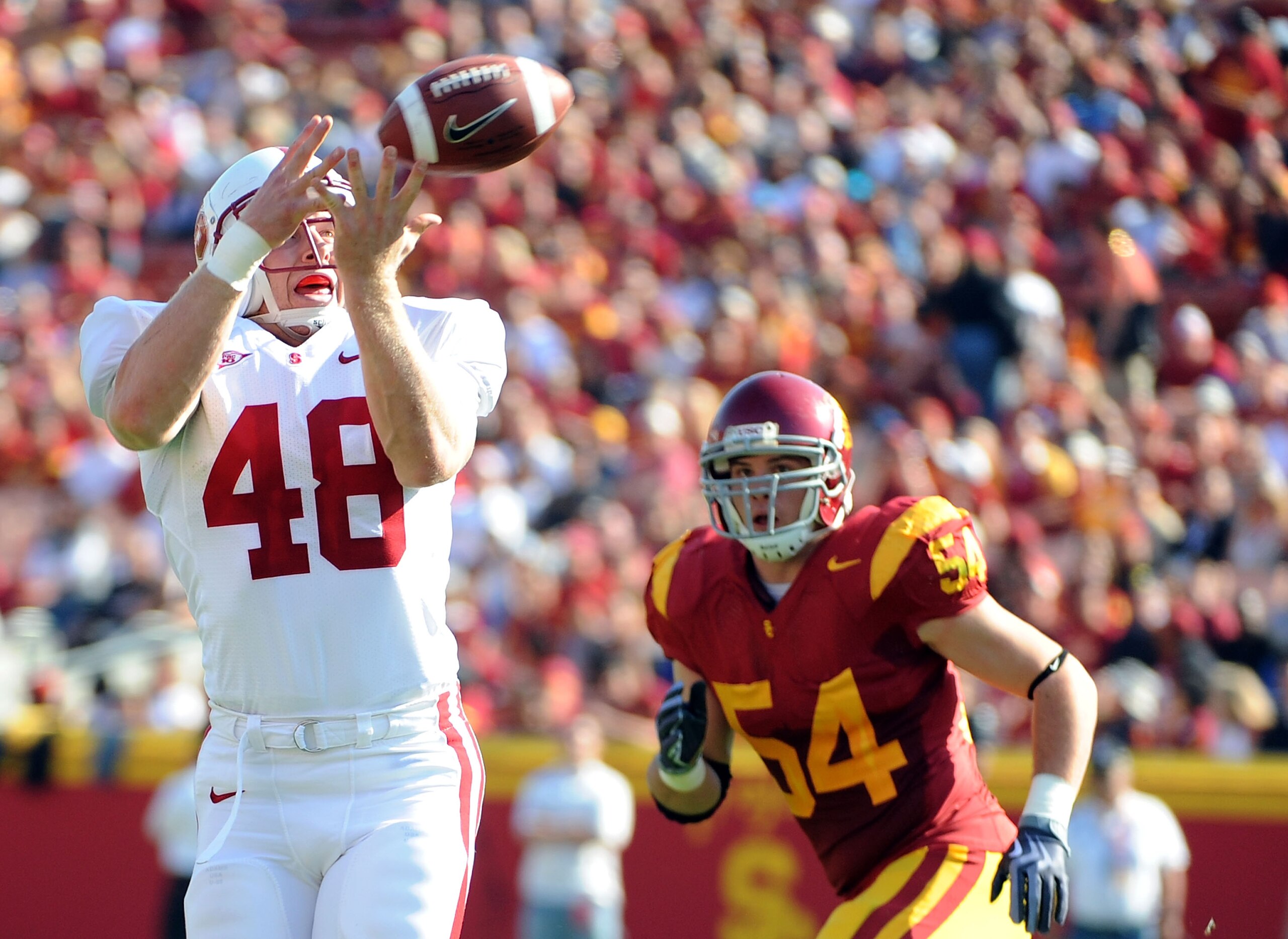 LOS ANGELES, CA - NOVEMBER 14:  Owen Marecic #48 of the Stanford Cardinal makes a catch in front of Chris Galippo #54 of the USC Trojans during the first half at the Los Angeles Memorial Coliseum on November 14, 2009 in Los Angeles, California.  (Photo by