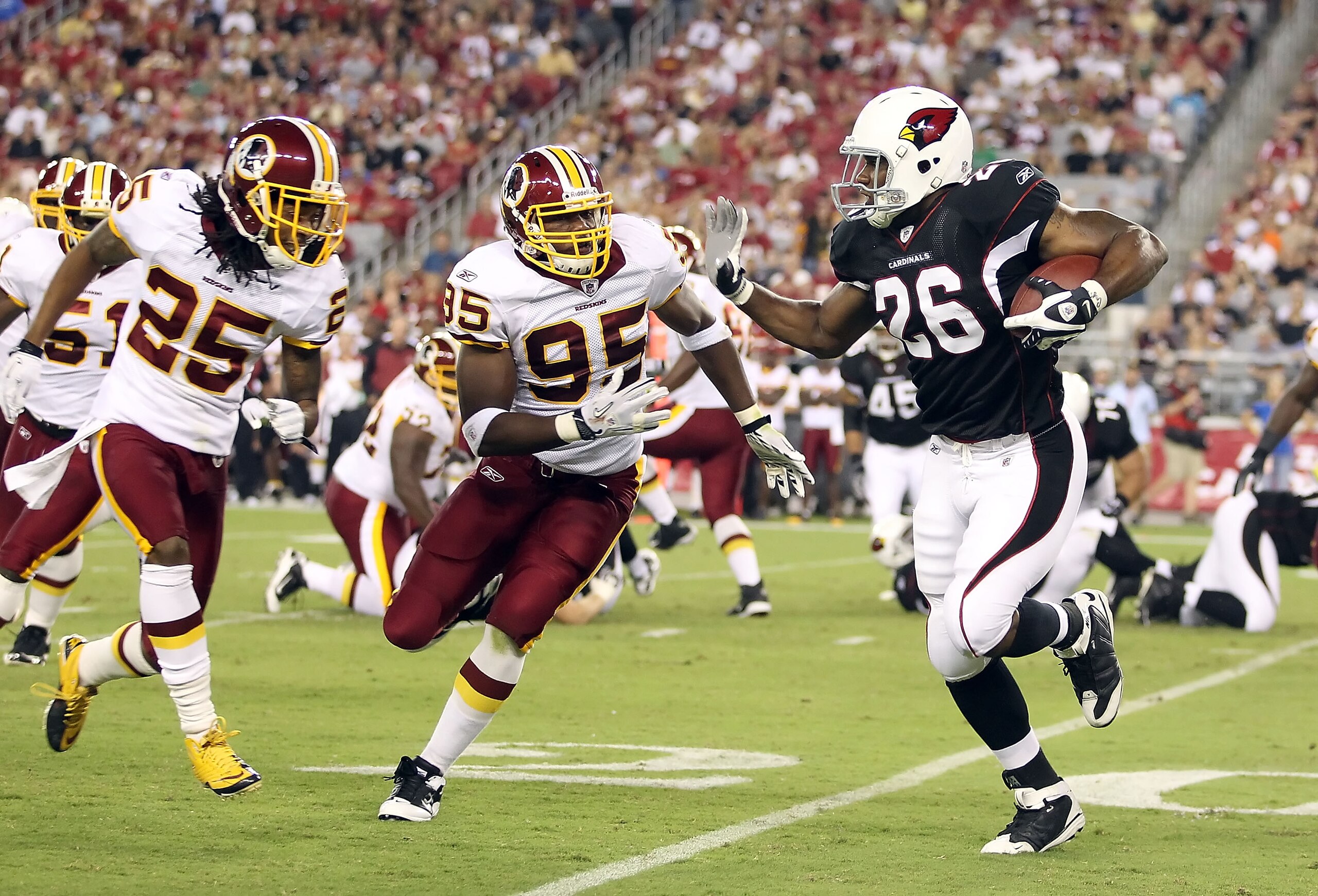 GLENDALE, AZ - SEPTEMBER 02:  Runningback Beanie Wells #26 of the Arizona Cardinals rushes the football against Chris Wilson #95 and Kevin Barnes #25 of the Washington Redskins during the first quarter of the preseason NFL game at the University of Phoeni