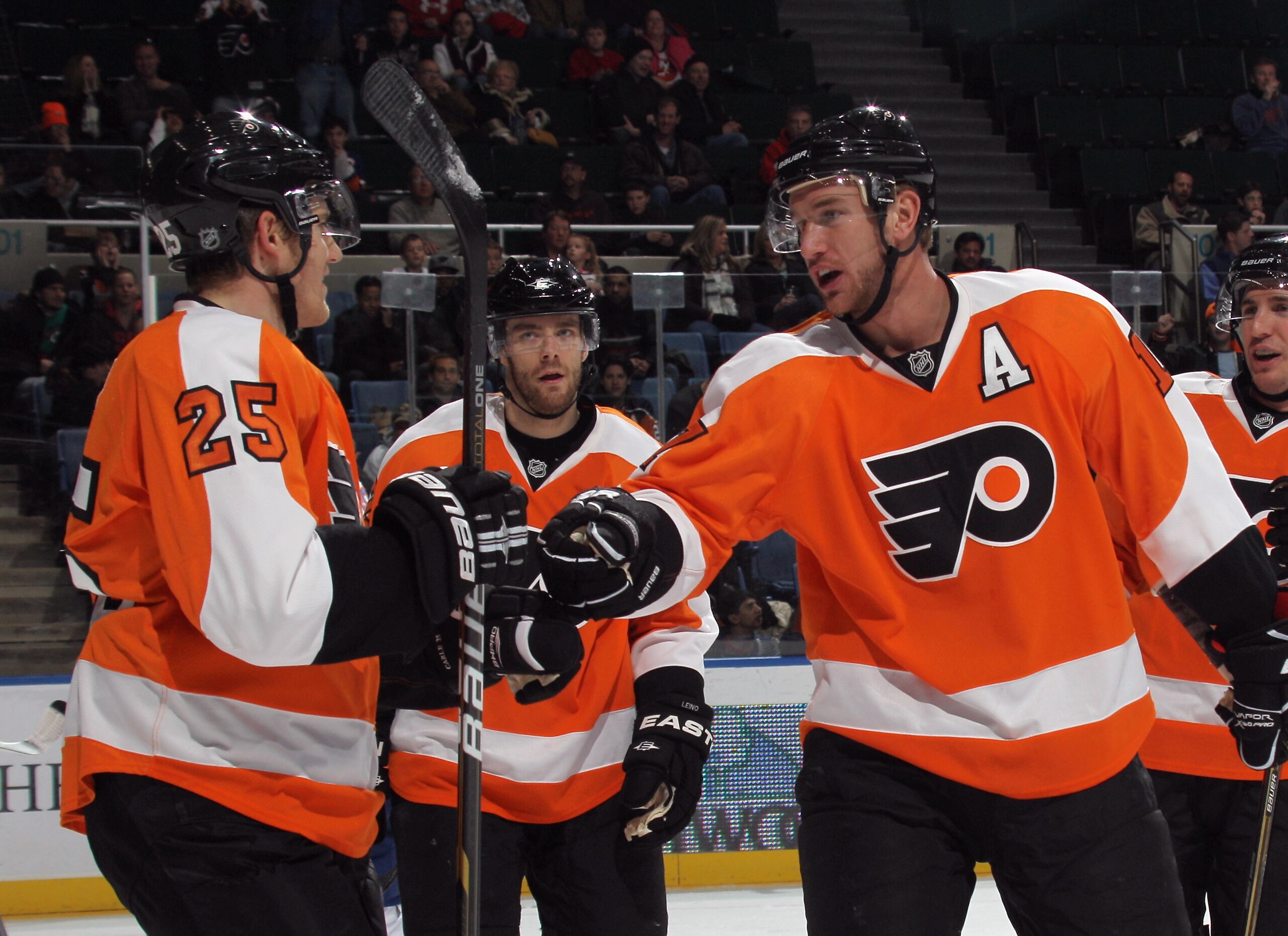 UNIONDALE, NY - DECEMBER 05: Matt Carle #25 of the Philadelphia Flyers scores at 13:42 of the first period against the New York Islanders and is joined by Jeff Carter #17 (R) at the Nassau Coliseum on December 5, 2010 in Uniondale, New York.  (Photo by Br