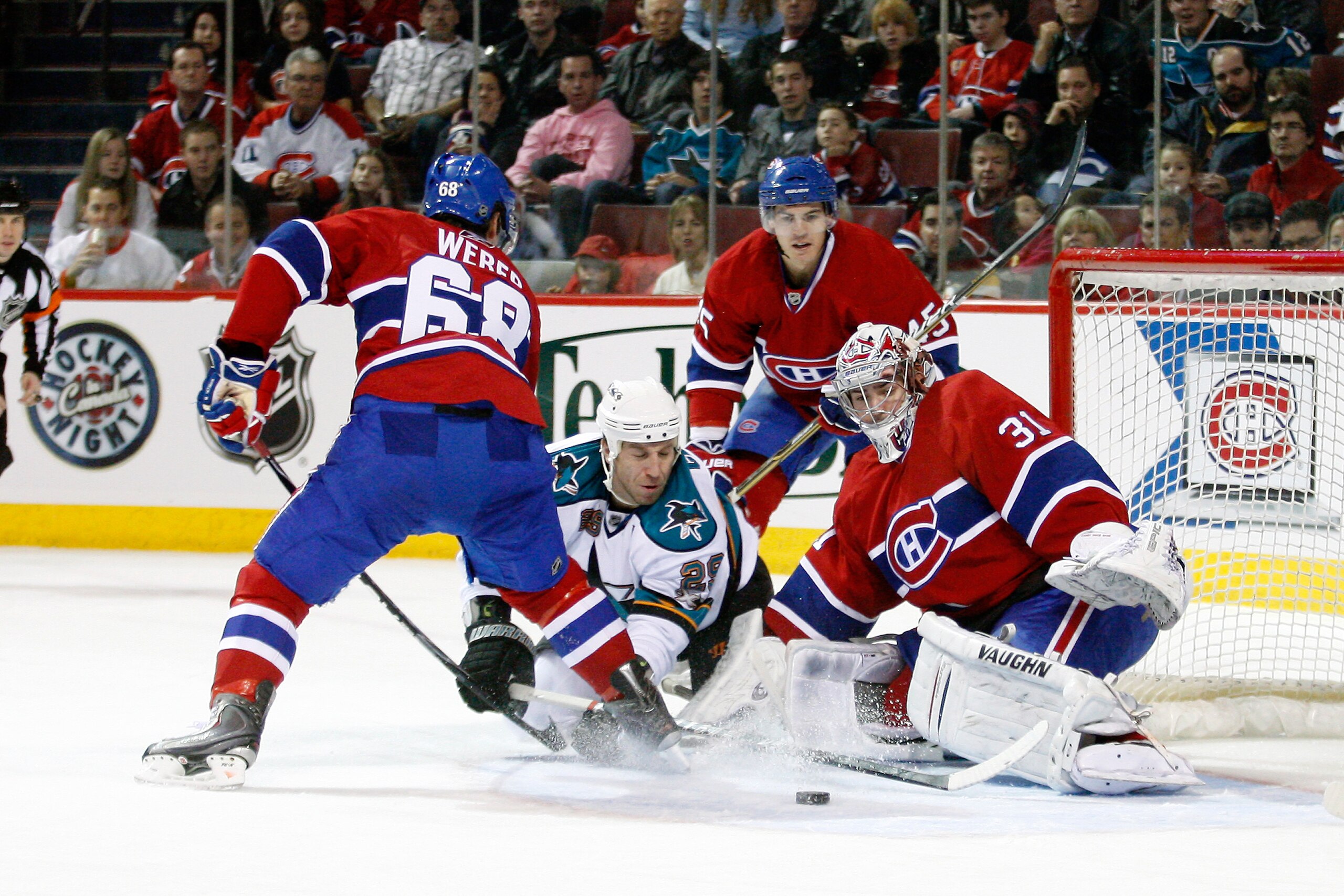 MONTREAL- DECEMBER 4:  Ryane Clowe #29 of the San Jose Sharks digs for the loose puck in front of Carey Price #31 and Yannick Weber #68 of the Montreal Canadiens during the NHL game at the Bell Centre on December 4, 2010 in Montreal, Quebec, Canada.  (Pho
