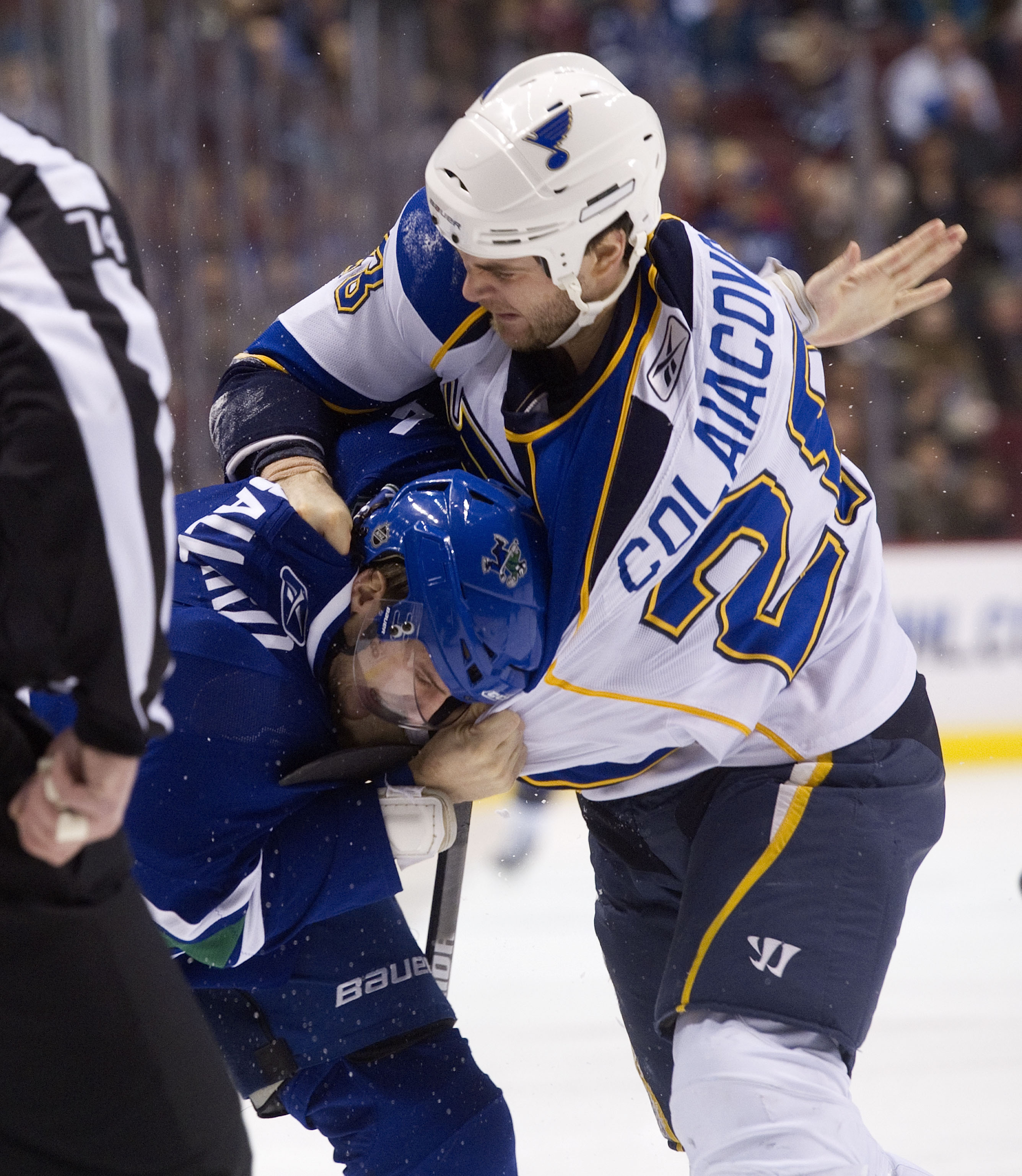 VANCOUVER, CANADA - DECEMBER 5: Carlo Colaiacovo #28 of the St Louis Blues connects with a punch on the back of the head of Keith Ballard #4 during fight in the first period in NHL action on December 05, 2010 at Rogers Arena in Vancouver, BC, Canada.  (Ph
