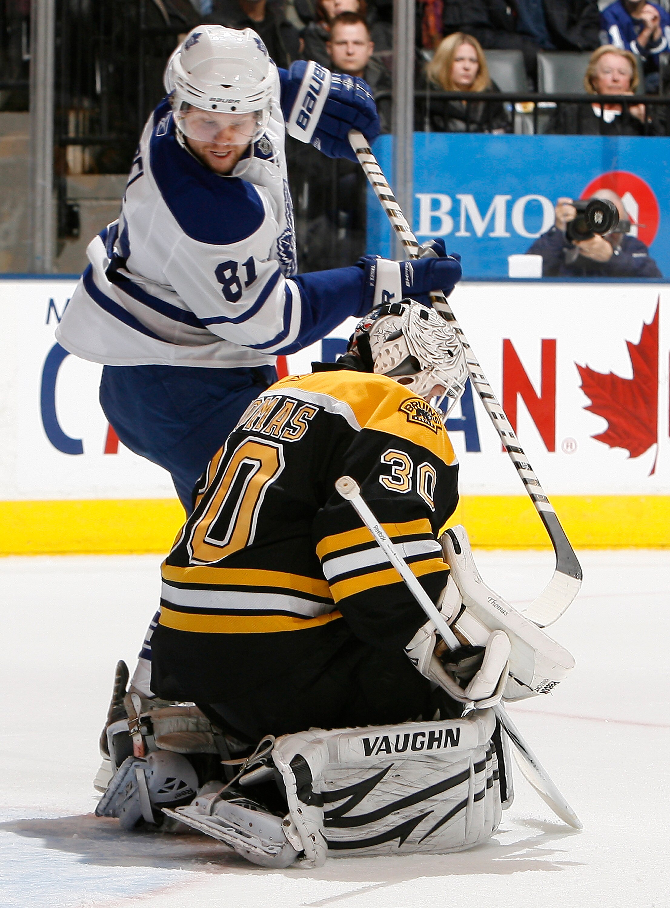 TORONTO, CANADA - DECEMBER 4: Phil Kessel #81 of the Toronto Maple Leafs digs for a rebound in front of Tim Thomas #30 of the Boston Bruins during game action at the Air Canada Centre December 4, 2010 in Toronto, Ontario, Canada. (Photo by Abelimages / Ge