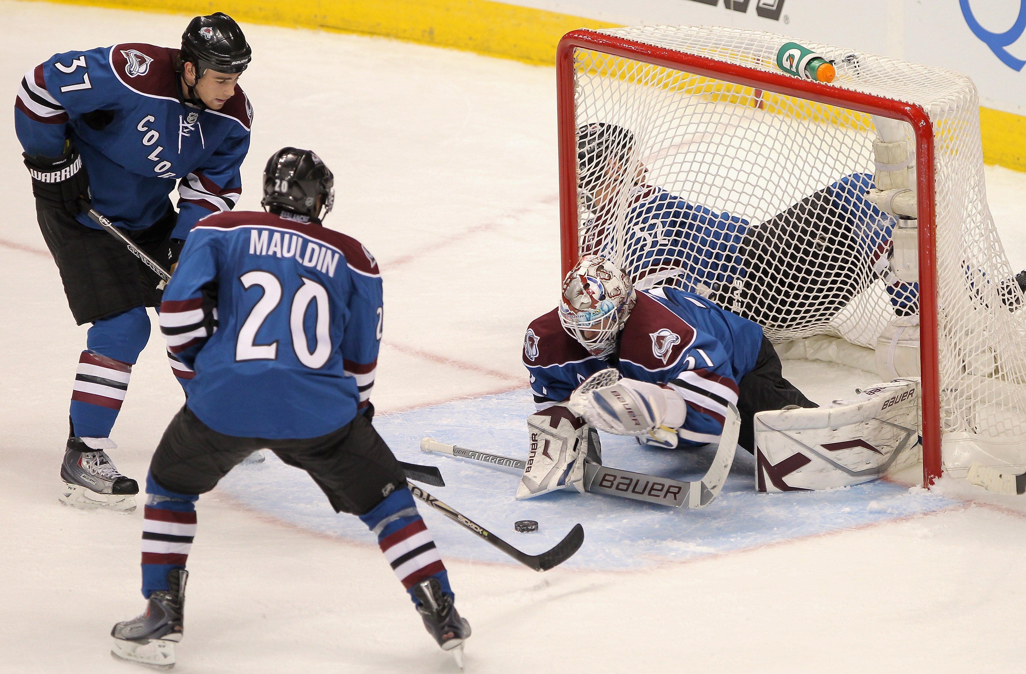 DENVER - NOVEMBER 15:  Goalie Peter Budaj #31 of the Colorado Avalanche collects the puck as he had 27 saves against the St. Louis Blues while Greg Mauldin #20 and Ryan O'Reilly #37 of the Avalanche look on at the Pepsi Center on November 15, 2010 in Denv
