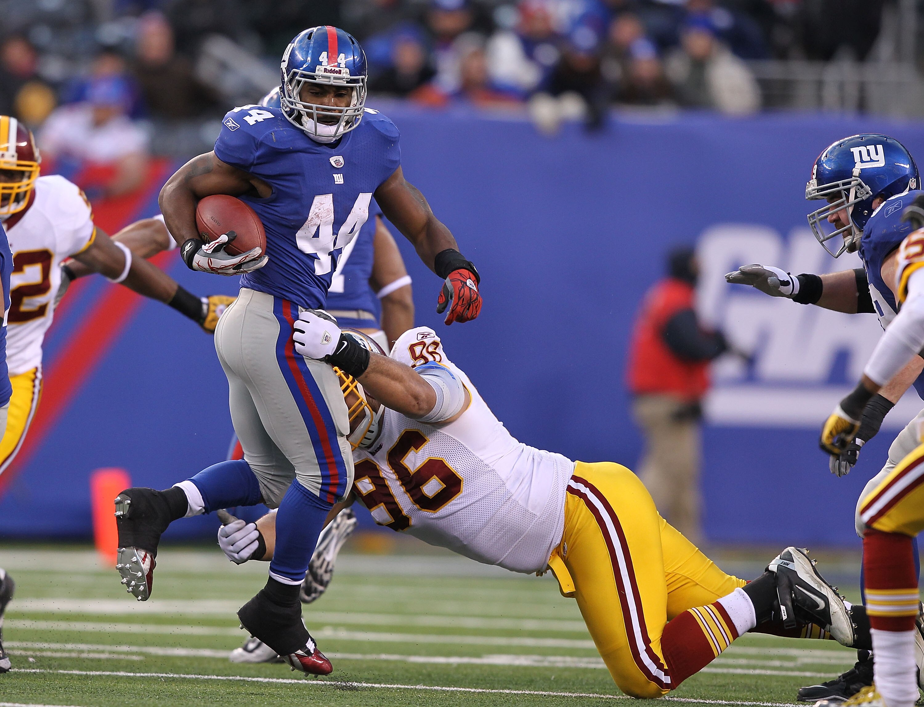 EAST RUTHERFORD, NJ - DECEMBER 05:  Ahmad Bradshaw #44 of the New York Giants runs with the ball as Ma'ake Kemoeatu #96 of the Washington Redskins tackles during their game on December 5, 2010 at The New Meadowlands Stadium in East Rutherford, New Jersey.