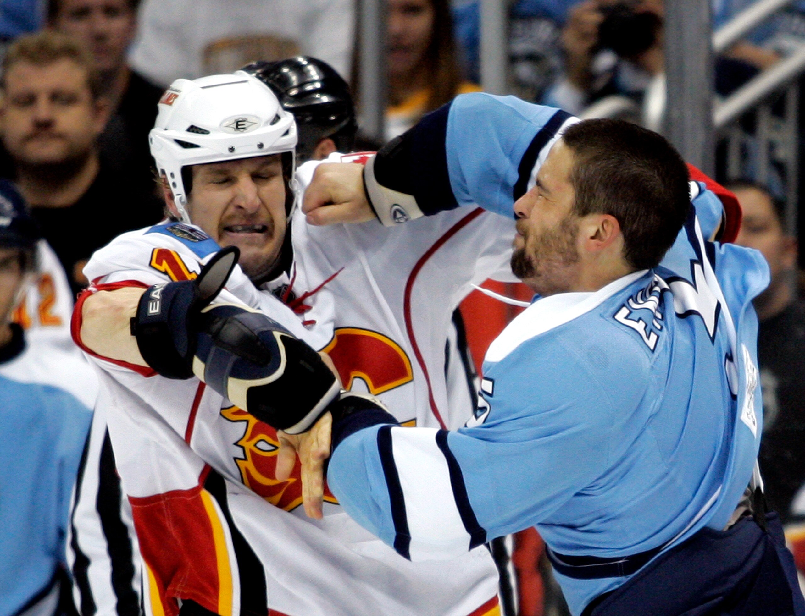 PITTSBURGH - NOVEMBER 27:  Tim Jackman #15 of the Calgary Flames and Deryk Engelland #5 of the Pittsburgh Penguins mix it up at Consol Energy Center on November 27, 2010 in Pittsburgh, Pennsylvania.  (Photo by Justin K. Aller/Getty Images)