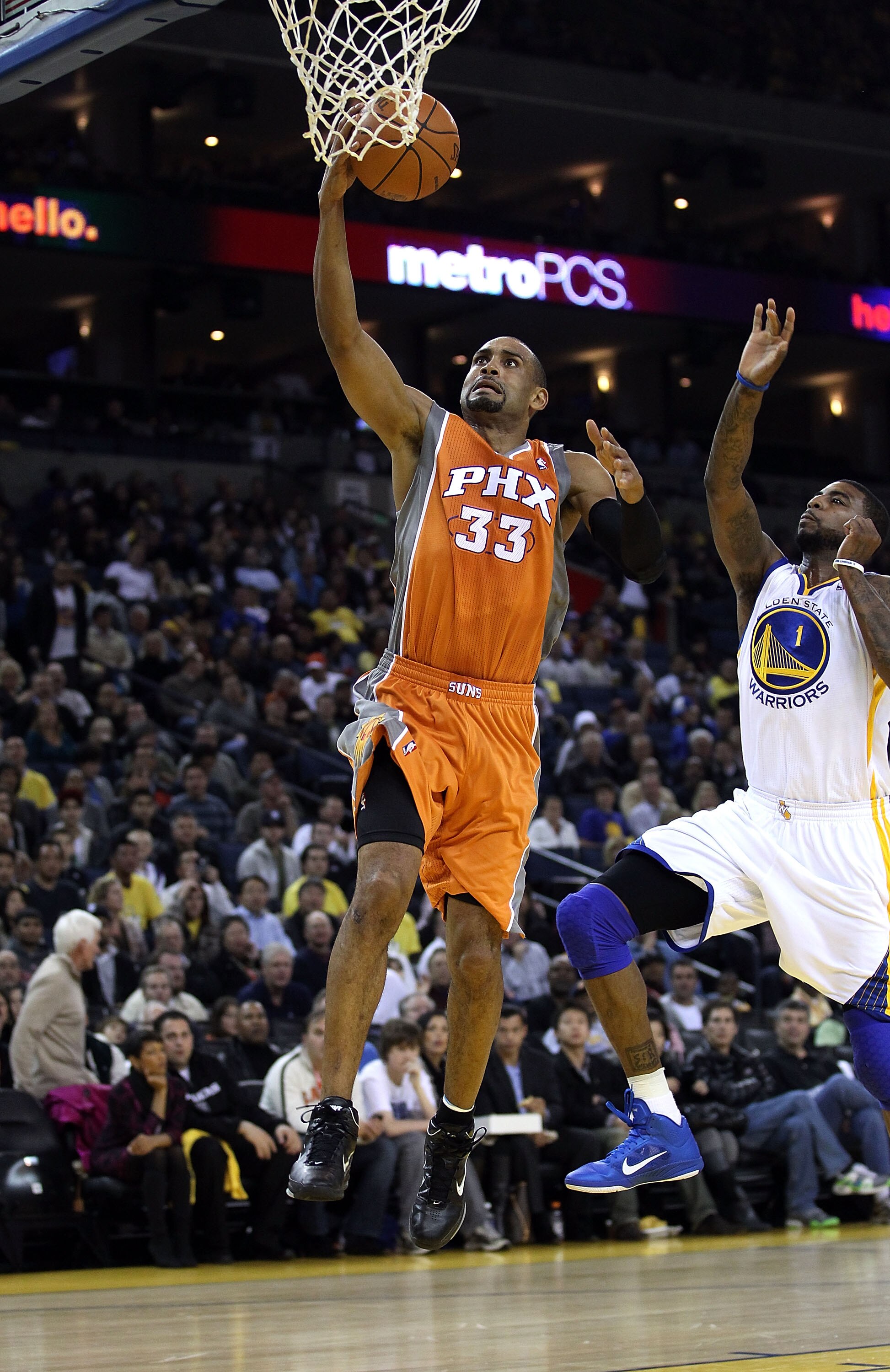 OAKLAND, CA - DECEMBER 02:  Grant Hill #33 of the Phoenix Suns drives on Dorell Wright #1 of the Golden State Warriors at Oracle Arena on December 2, 2010 in Oakland, California. NOTE TO USER: User expressly acknowledges and agrees that, by downloading an