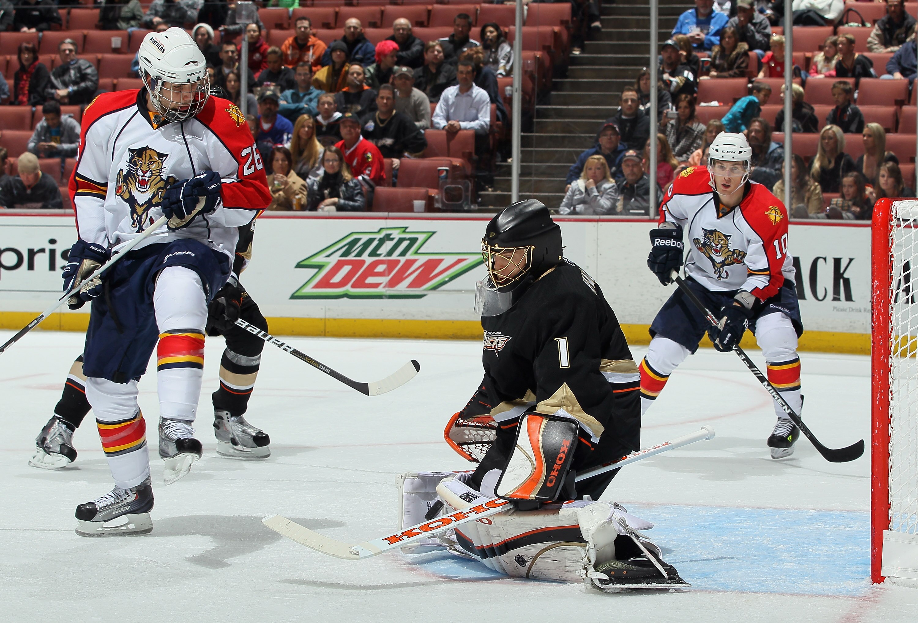 ANAHEIM, CA - DECEMBER 01:  Goaltender Jonas Hiller #1 of the Anaheim Ducks makes a save on a deflection by Steve Bernier (L) #26 of the Florida Panthers during the third period at the Honda Center on December 1, 2010 in Anaheim, California. The Ducks def