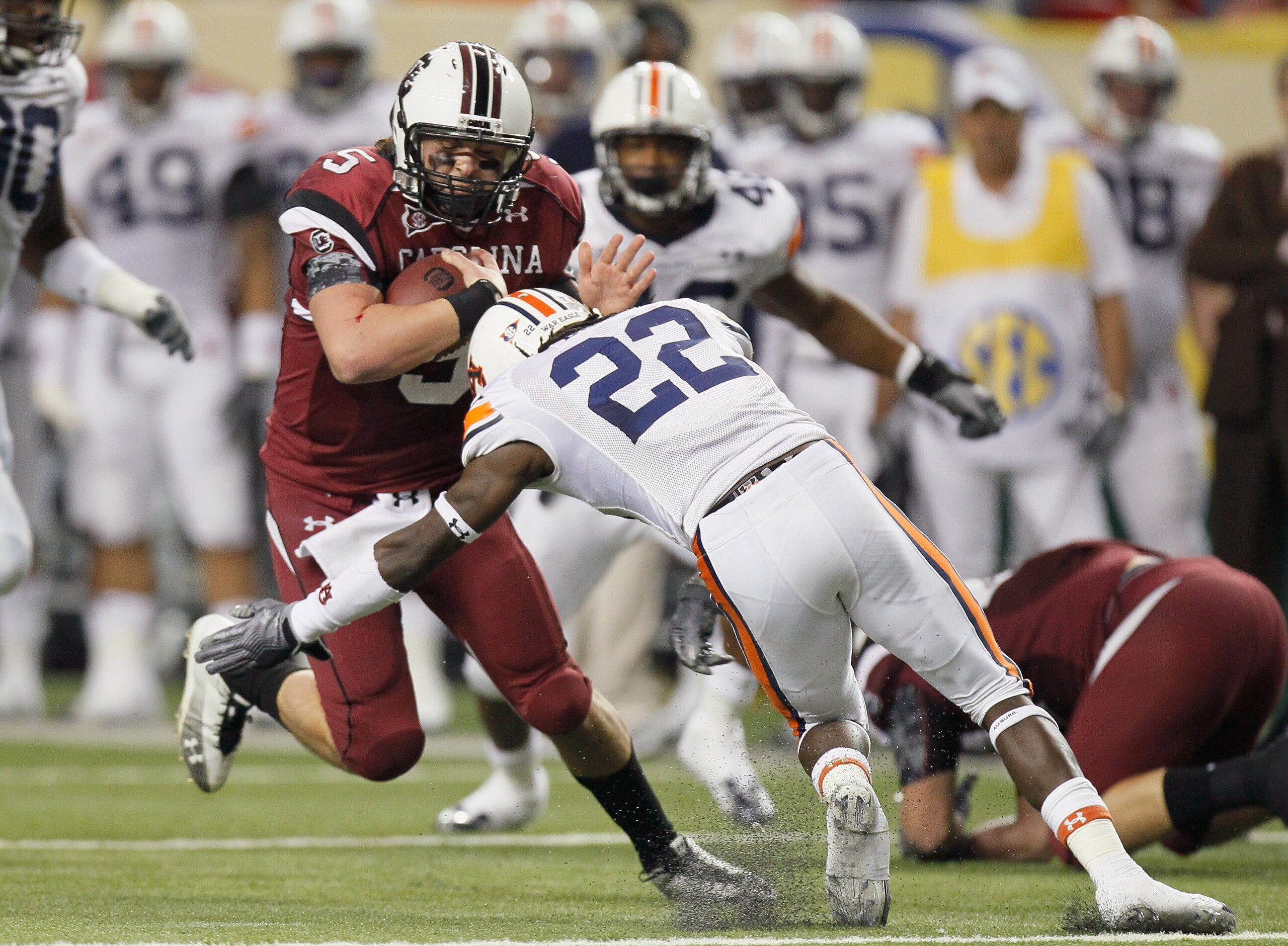 ATLANTA, GA - DECEMBER 04:  Stephen Garcia #5 of the South Carolina Gamecocks is tackled by T'Sharvan Bell #22 of the Auburn Tigers during the 2010 SEC Championship at Georgia Dome on December 4, 2010 in Atlanta, Georgia.  (Photo by Kevin C. Cox/Getty Ima