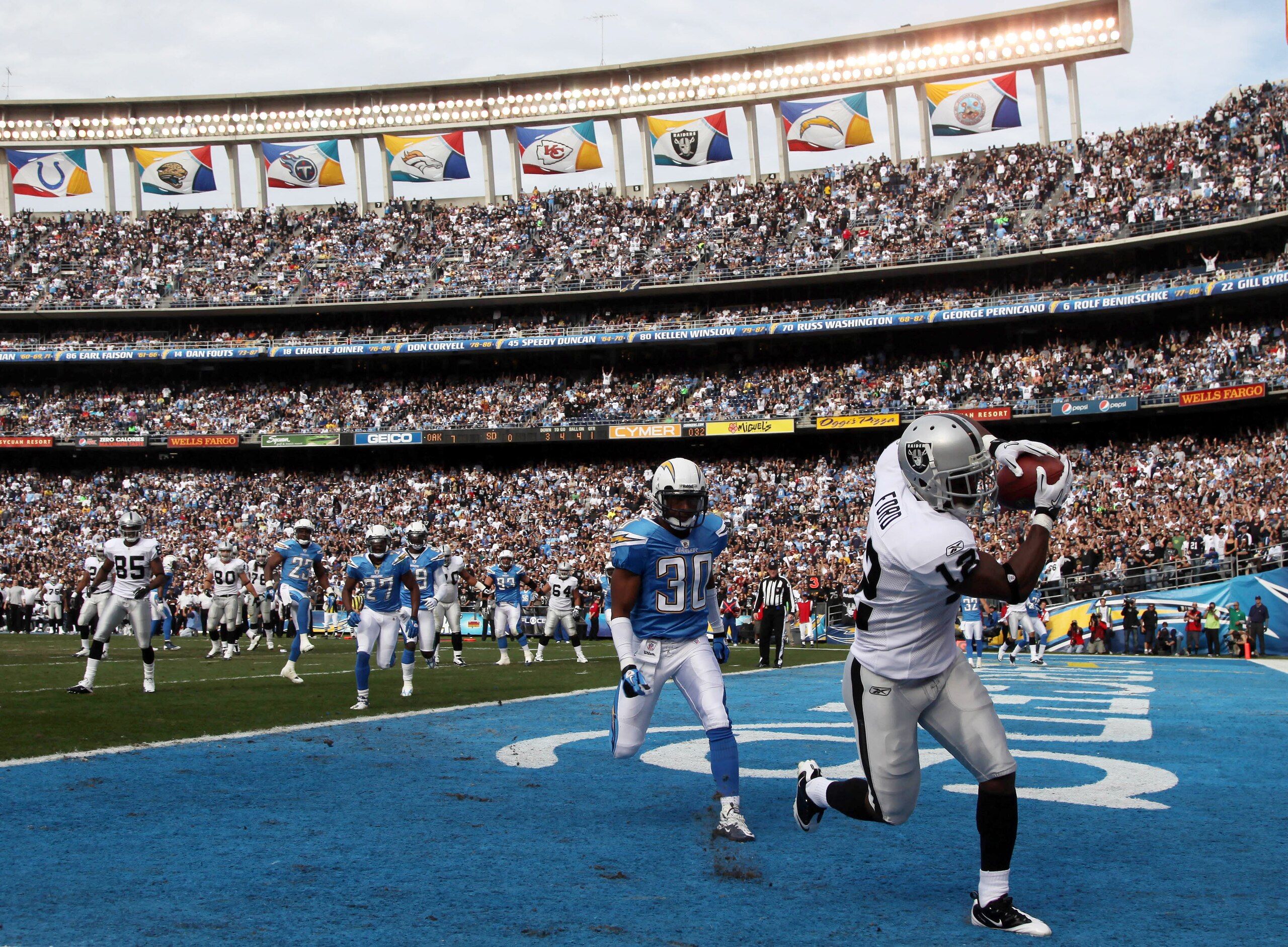 SAN DIEGO, CA - DECEMBER 5:  Wide Receiver Jacoby Ford #12 of the Oakland Raiders catches a touchdown catch in front of Donald Strickland #30 of the San Diego Chargers a during their NFL game at Qualcomm Stadium on December 5, 2010 in San Diego, Californi