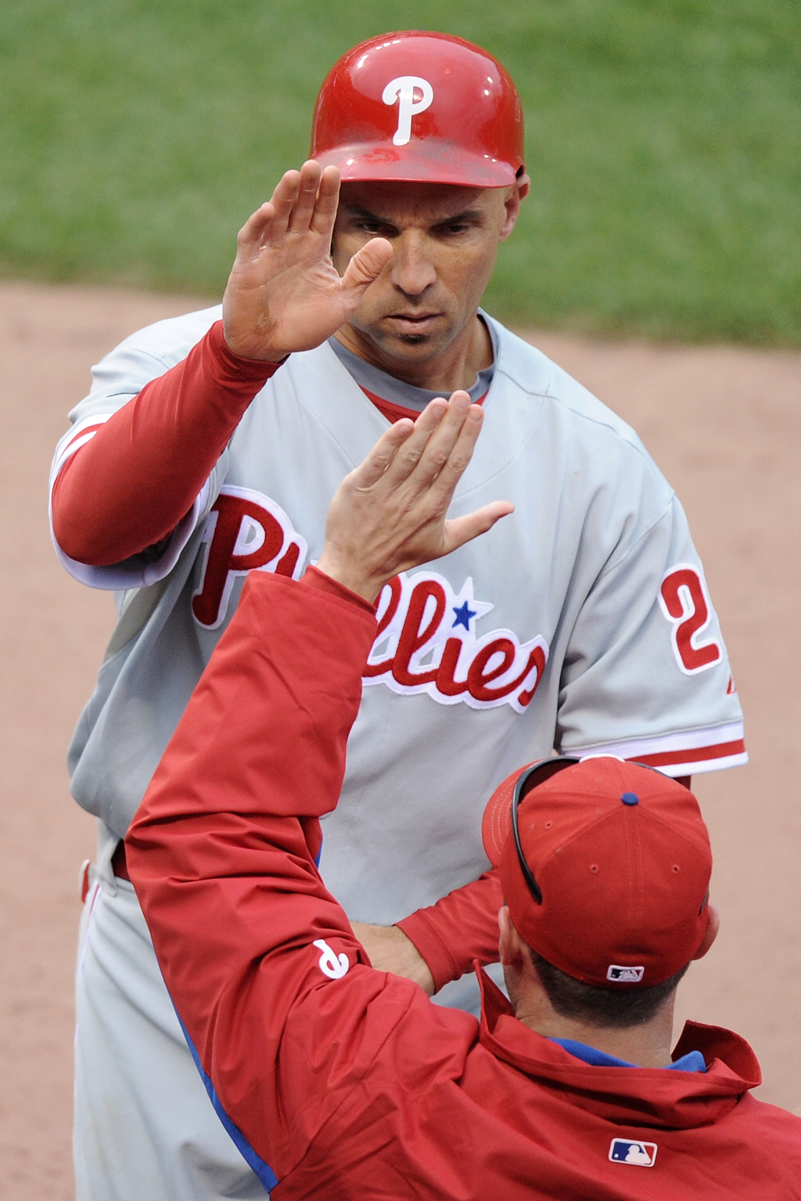 SAN FRANCISCO - OCTOBER 21:  Raul Ibanez #29 of the Philadelphia Phillies celebrates in the dugout after scoring on an error by Aubrey Huff #17 of the San Francisco Giants in the third inning of Game Five of the NLCS during the 2010 MLB Playoffs at AT&T P