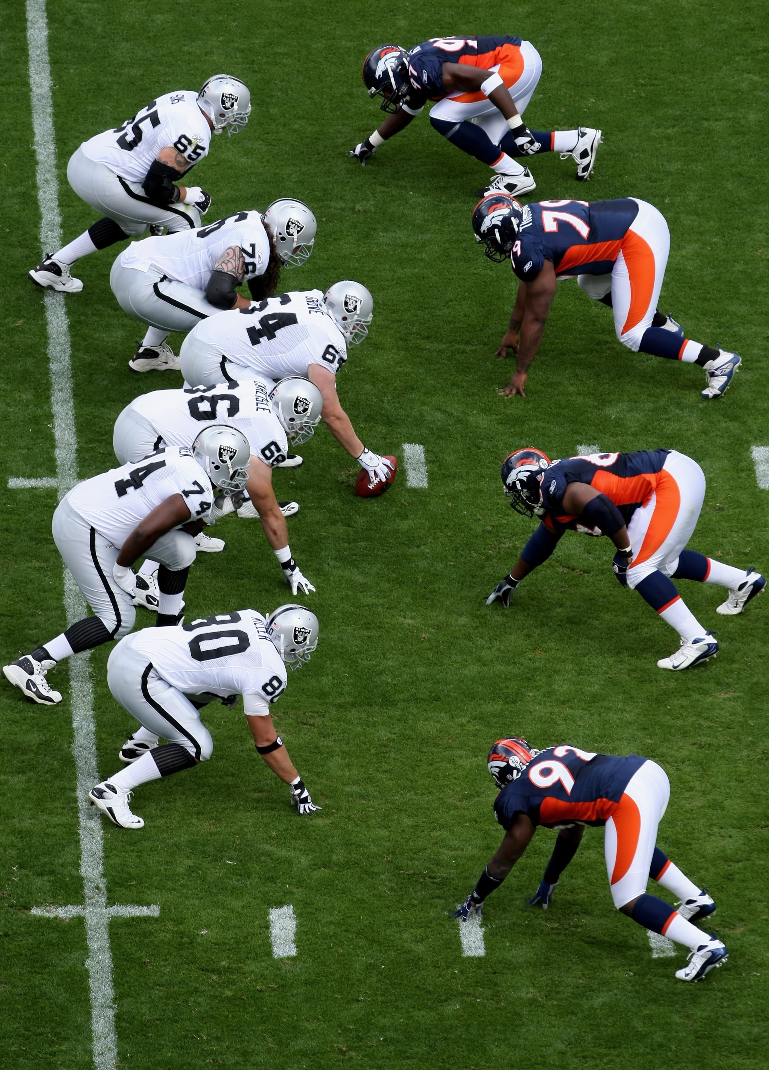 DENVER - SEPTEMBER 16:  The Raiders offensive line and the Broncos defensive line square off as the Denver Broncos defeated the Oakland Raiders 23-20 in overtime during week two NFL action at Invesco Field at Mile High on September 16, 2007 in Denver, Col