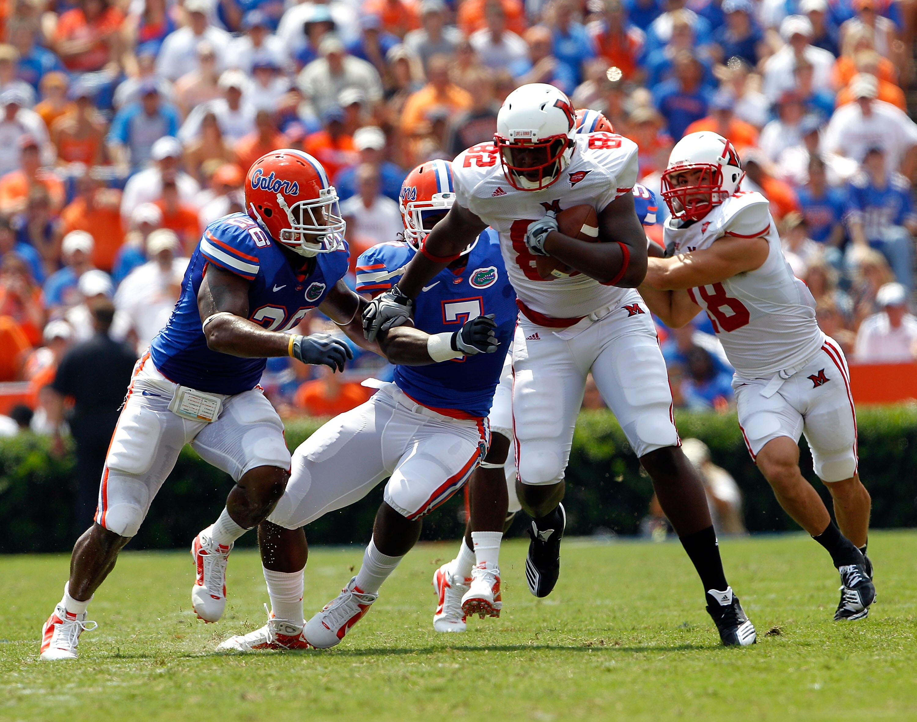 GAINESVILLE, FL - SEPTEMBER 04:  Kendrick Bruton #82 of the Miami University RedHawks breaks the tackle of Ronald Powell #7 of the Florida Gators at Ben Hill Griffin Stadium on September 4, 2010 in Gainesville, Florida.  (Photo by Sam Greenwood/Getty Imag