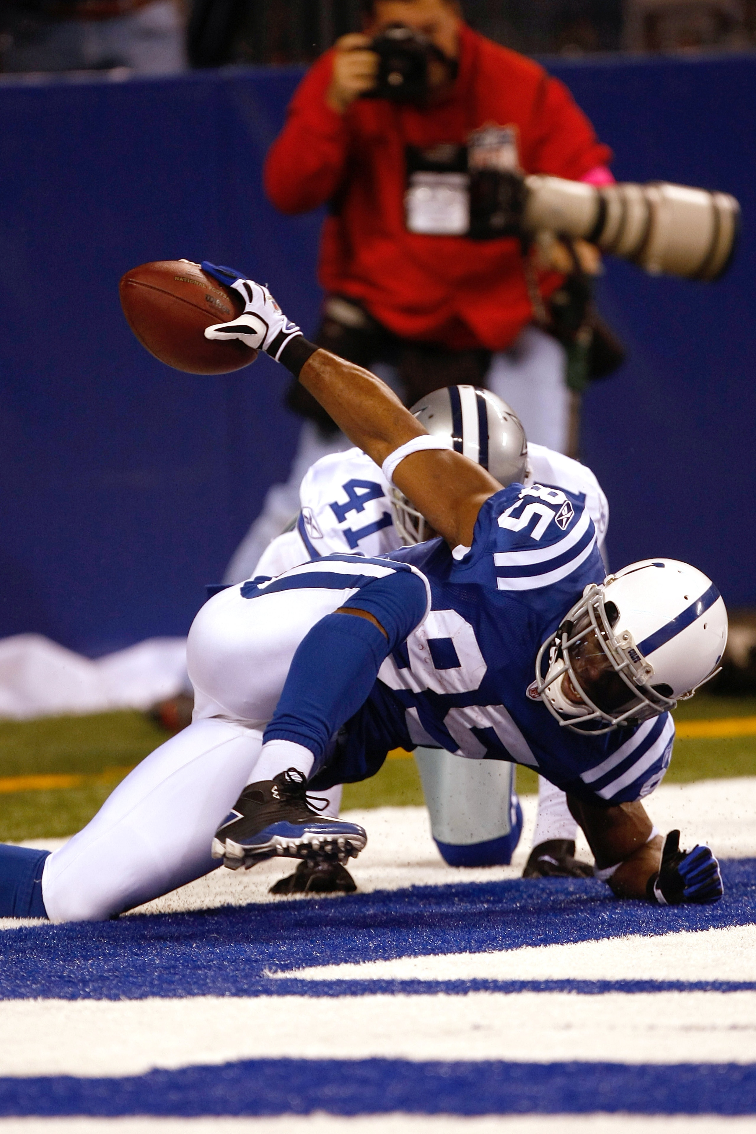 INDIANAPOLIS, IN - DECEMBER 05: Pierre Garcon #85 of the Indianapolis Colts scores a touchdown as Terrence Newman #41 of the Dallas Cowboys defends at Lucas Oil Stadium on December 5, 2010 in Indianapolis, Indiana.  (Photo by Scott Boehm/Getty Images)