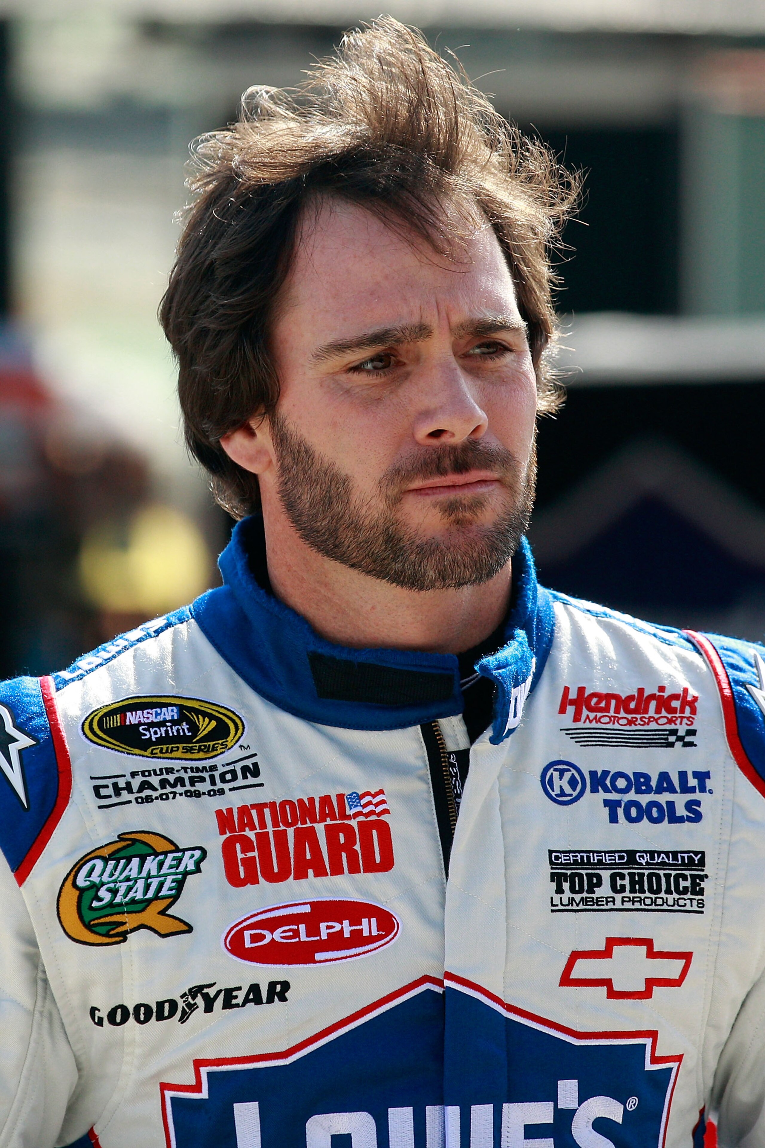 HOMESTEAD, FL - NOVEMBER 20:  Jimmie Johnson, driver of the #48 Lowe's Chevrolet, stands in the garage area during practice for the NASCAR Sprint Cup Series Ford 400 at Homestead-Miami Speedway on November 20, 2010 in Homestead, Florida.  (Photo by Chris