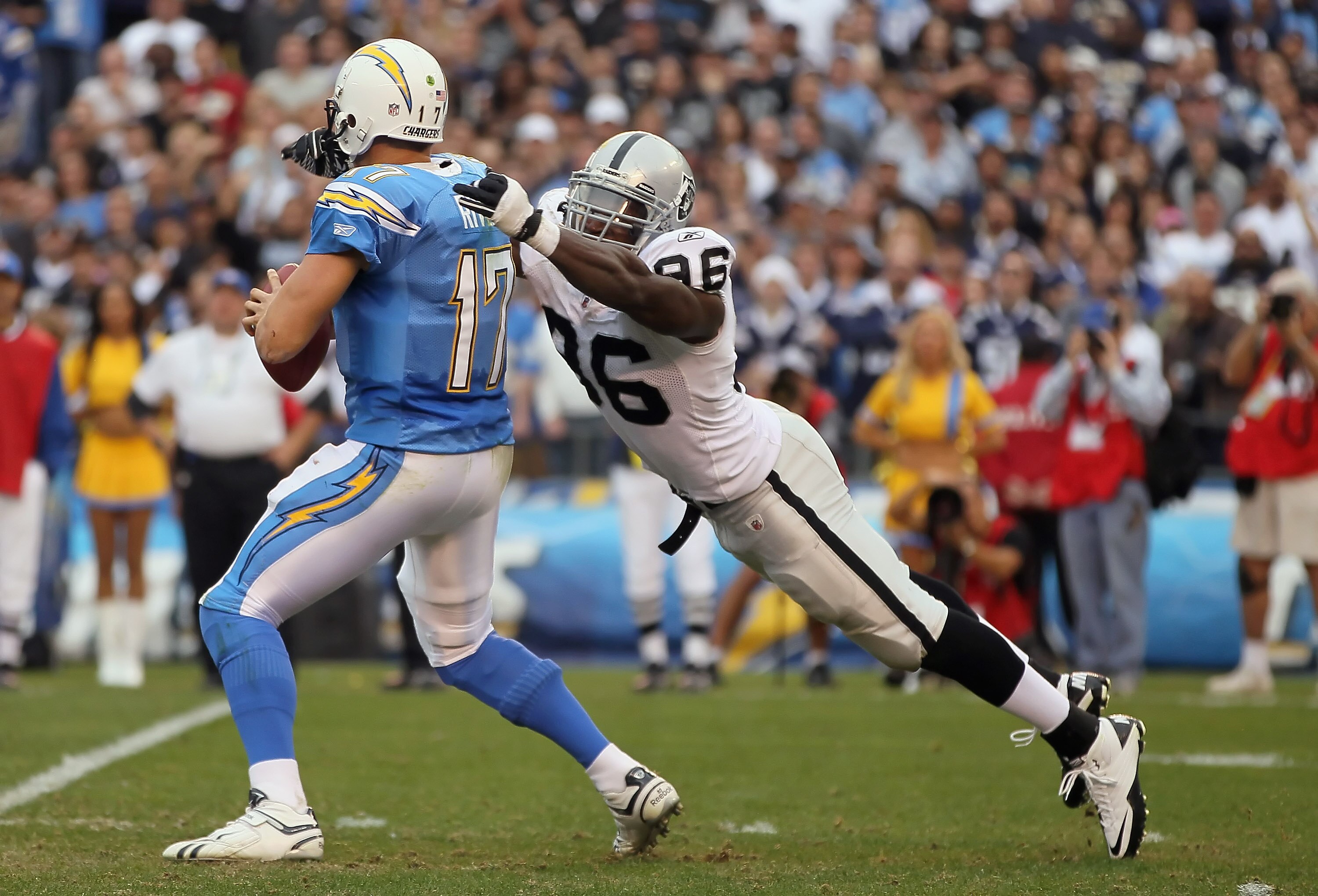 SAN DIEGO - DECEMBER 05:  Quarterback Philip Rivers #17 of the San Diego Chargers is sacked by Kamerion Wimbley #96 of the Oakland Raiders at Qualcomm Stadium on December 5, 2010 in San Diego, California. The Raiders defeated the Chargers 28-13.  (Photo b
