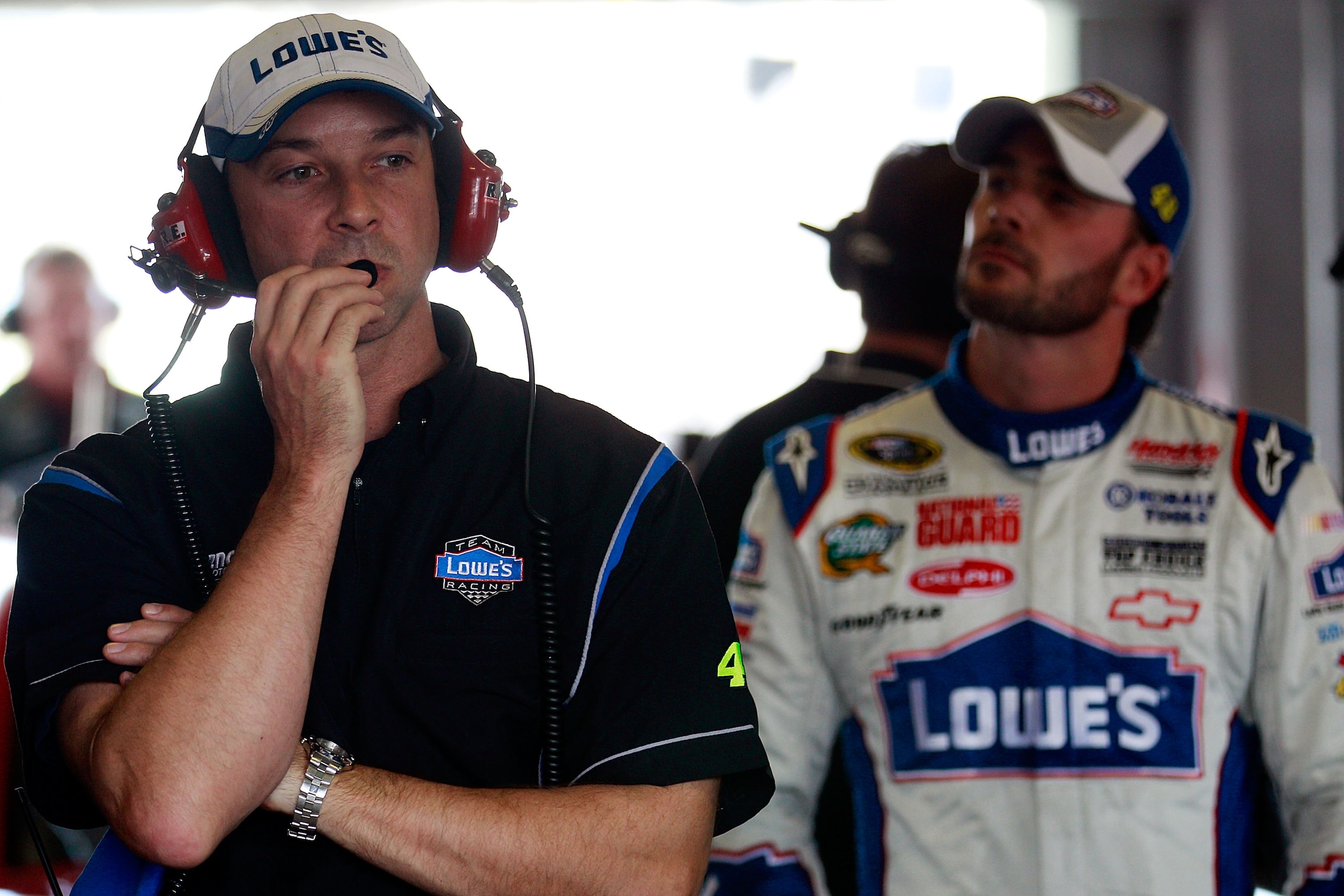 HOMESTEAD, FL - NOVEMBER 20:  Chad Knaus (L), stands in the garage with with Jimmie Johnson, driver of the #48 Lowe's Chevrolet, during practice for the NASCAR Sprint Cup Series Ford 400 at Homestead-Miami Speedway on November 20, 2010 in Homestead, Flori