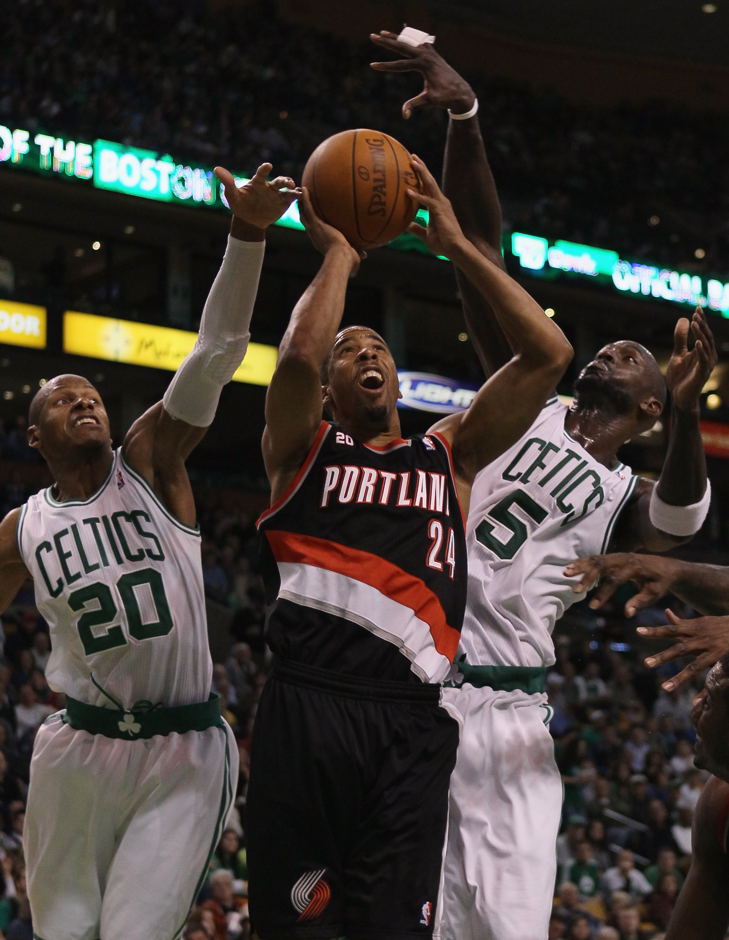 BOSTON - DECEMBER 01:  Andre Miller #24 of the Portland Trailblazers heads for the basket as Ray Allen #20 and Kevin Garnett #5 of the Boston Celtics defend on December 1, 2010 at the TD Garden in Boston, Massachusetts. The Celtics defeated the Trailblaze