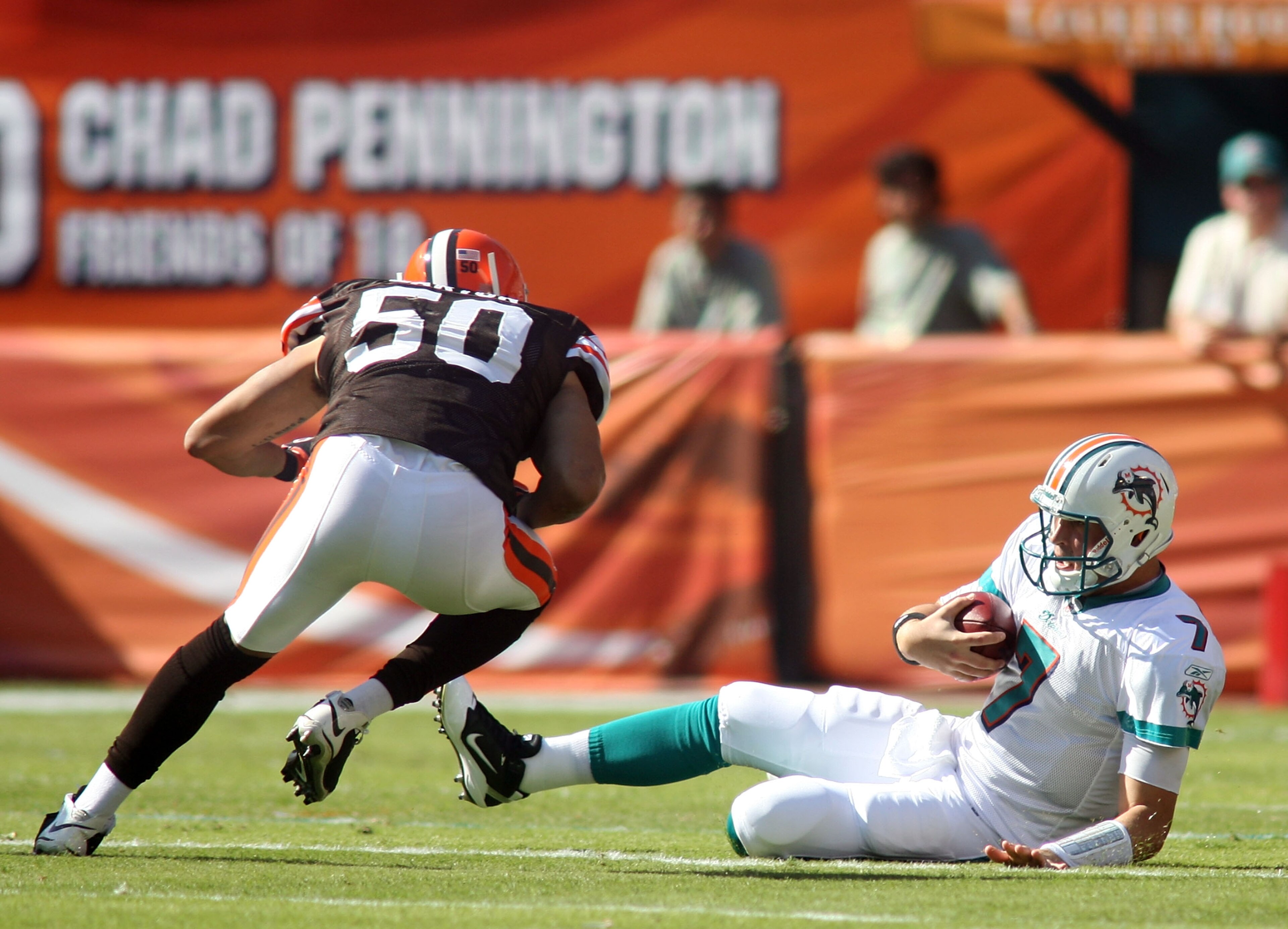 MIAMI - DECEMBER 05:  Quarterback Chad Henne #7 of the Miami Dolphins is hit late by Linebacker Eric Barton #50 of the Cleveland Browns while sliding at Sun Life Stadium on December 5, 2010 in Miami, Florida.  (Photo by Marc Serota/Getty Images)