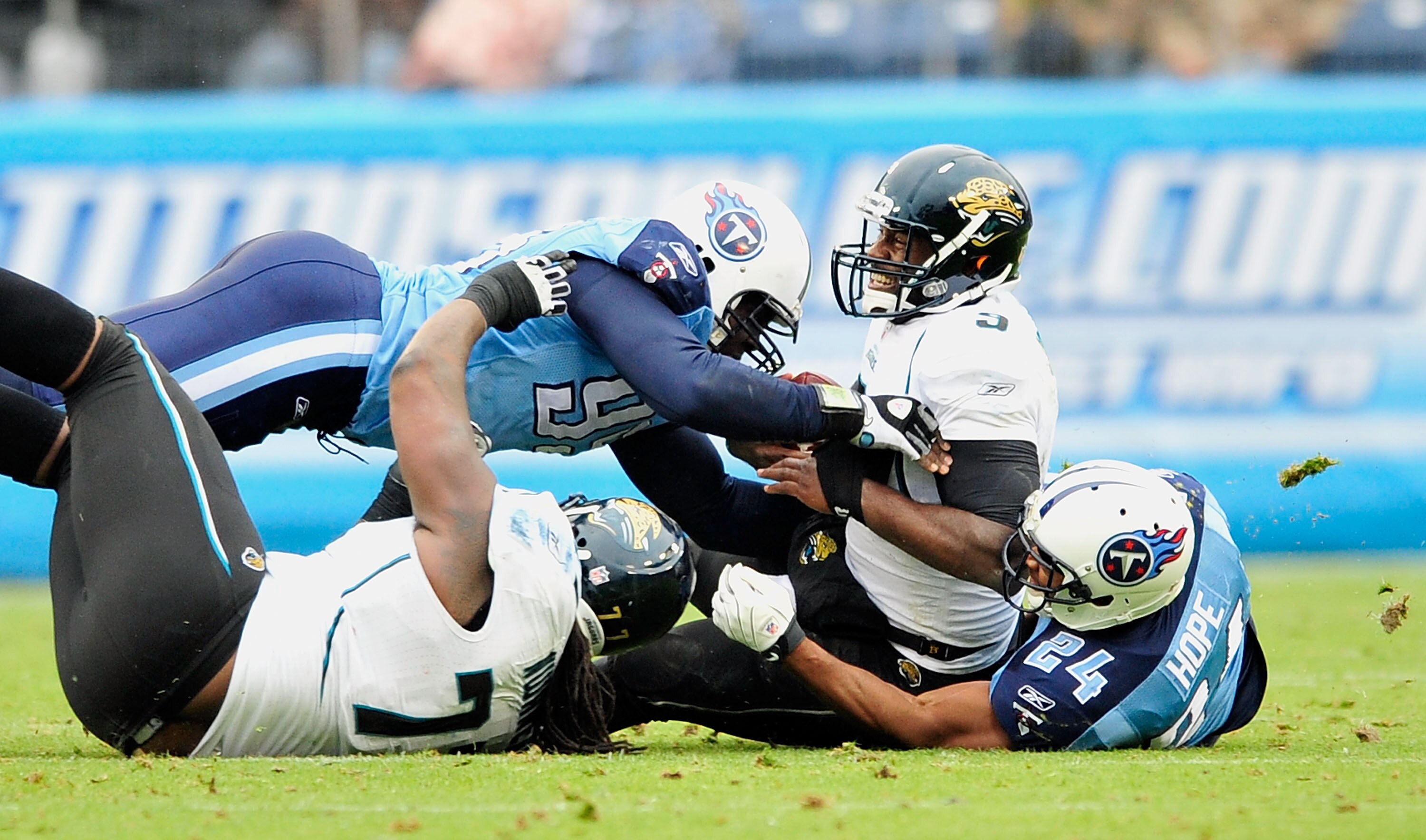 NASHVILLE, TN - DECEMBER 05:  Marques Douglas #99 and Chris Hope #24 of the Tennessee Titans sack quarterback David Garrard #9 of the Jacksonville Jaguars at LP Field on December 5, 2010 in Nashville, Tennessee. The Jaguars won 17-6. (Photo by Grant Halve
