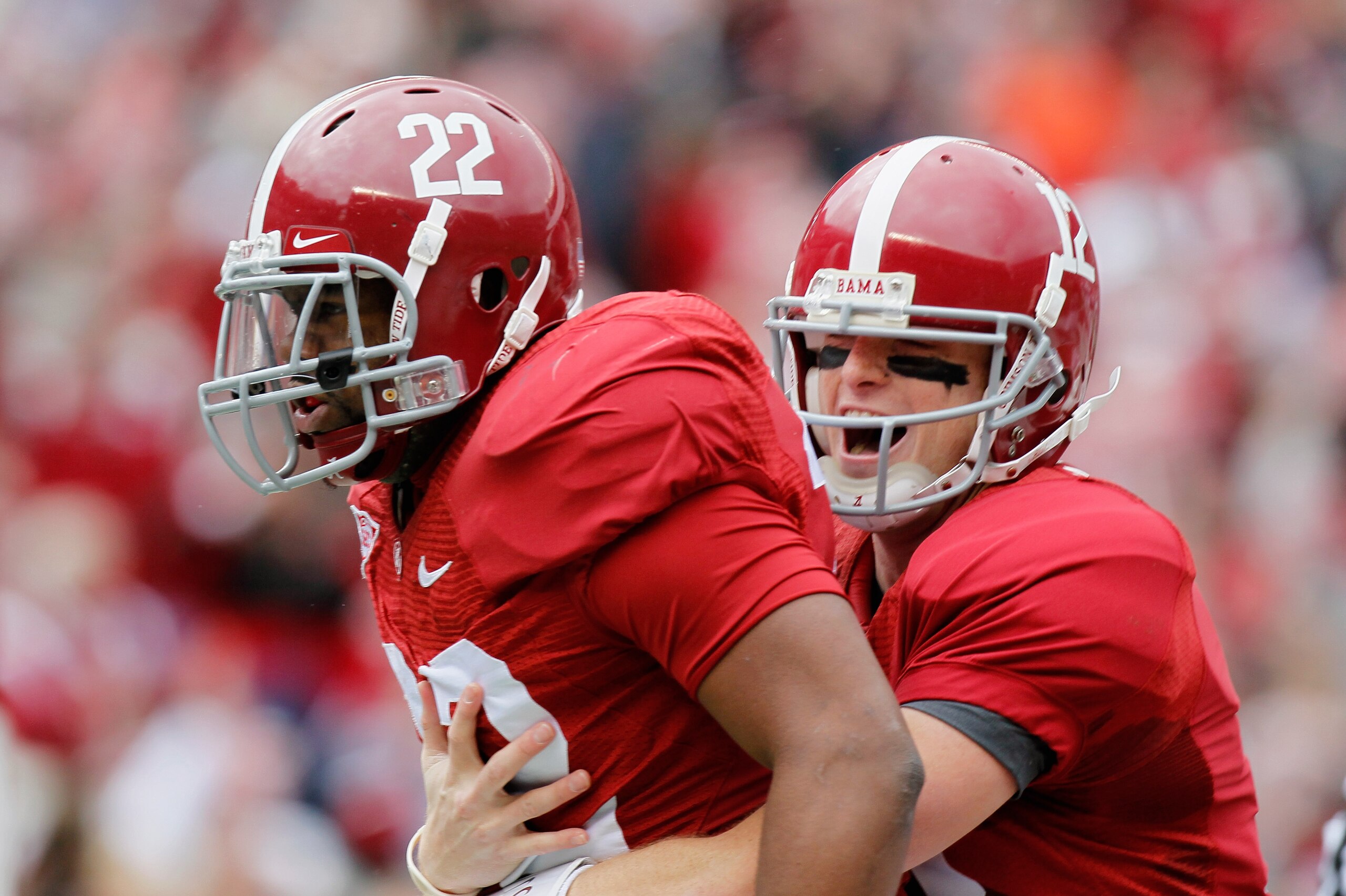 TUSCALOOSA, AL - NOVEMBER 26:  Quarterback Greg McElroy #12 and Mark Ingram #22 of the Alabama Crimson Tide react after Ingram's touchdown against the Auburn Tigers at Bryant-Denny Stadium on November 26, 2010 in Tuscaloosa, Alabama.  (Photo by Kevin C. C