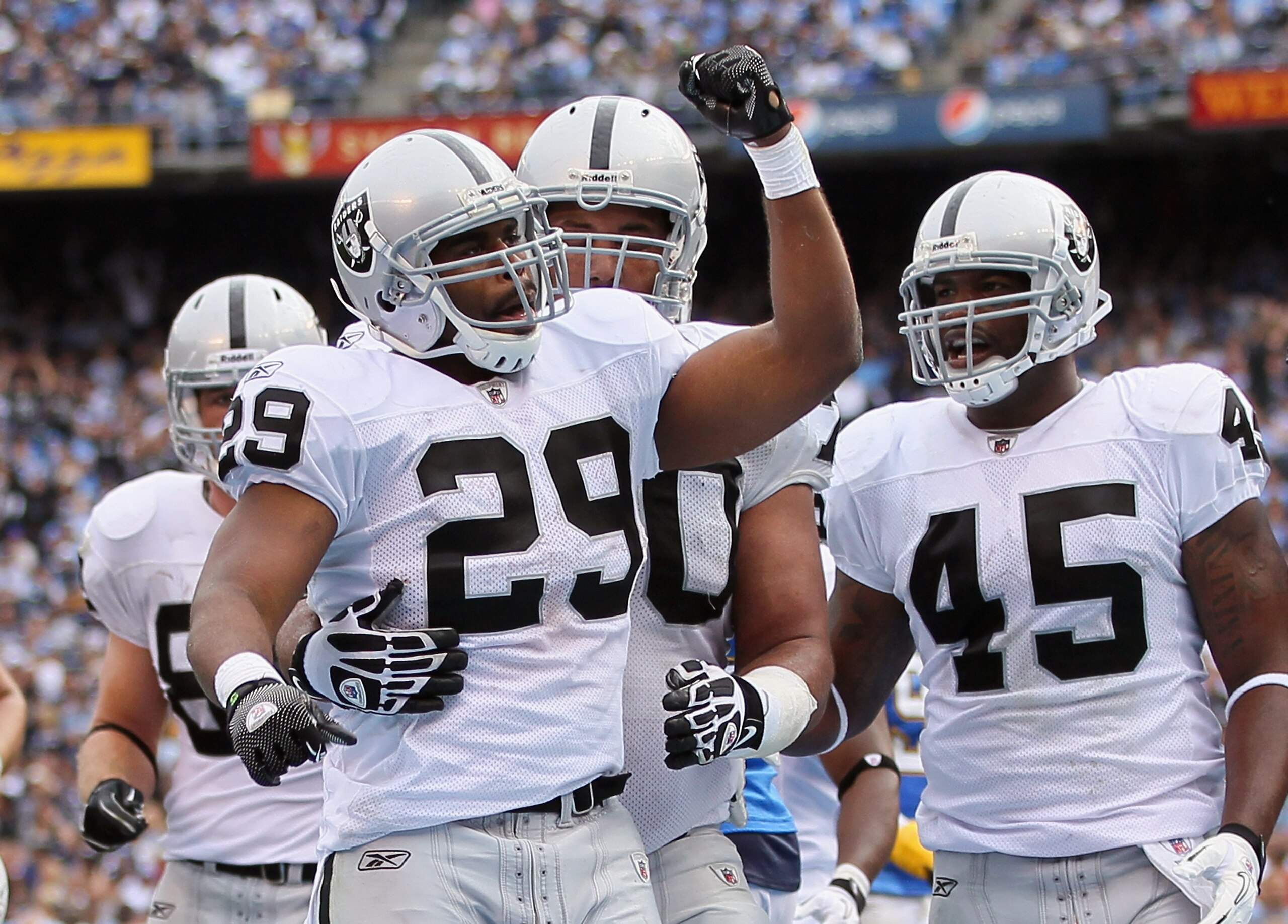 SAN DIEGO - DECEMBER 05: (L-R) Michael Bush #29, Langston Walker #70 and Marcel Reece #45 of the Oakland Raiders celebrate Bush's touchdown in the second quarter against the San Diego Chargers at Qualcomm Stadium on December 5, 2010 in San Diego, Califor SAN DIEGO - DECEMBER 05: (L-R) Michael Bush #29, Langston Walker #70 and Marcel Reece #45 of the Oakland Raiders celebrate Bush's touchdown in the second quarter against the San Diego Chargers at Qualcomm Stadium on December 5, 2010 in San Diego, Califor
