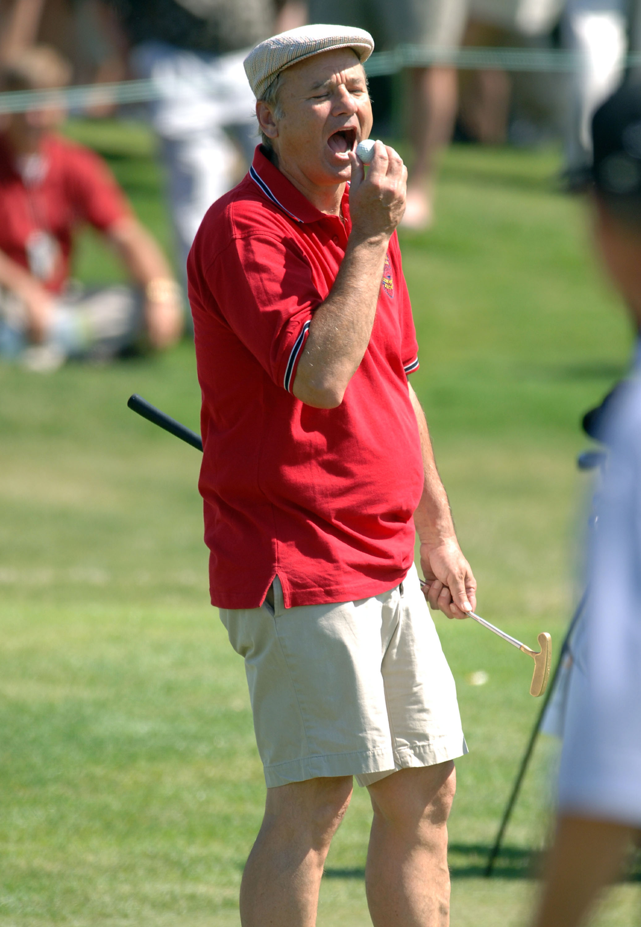 UNITED STATES - MAY 25:  Bill Murray jokes with the crowd as he pretends to eat his ball during the Fedex St. Jude Classic Memorial Pro-Am in Memphis, Tennessee on May 25, 2005.  (Photo by Joe Murphy/Getty Images)